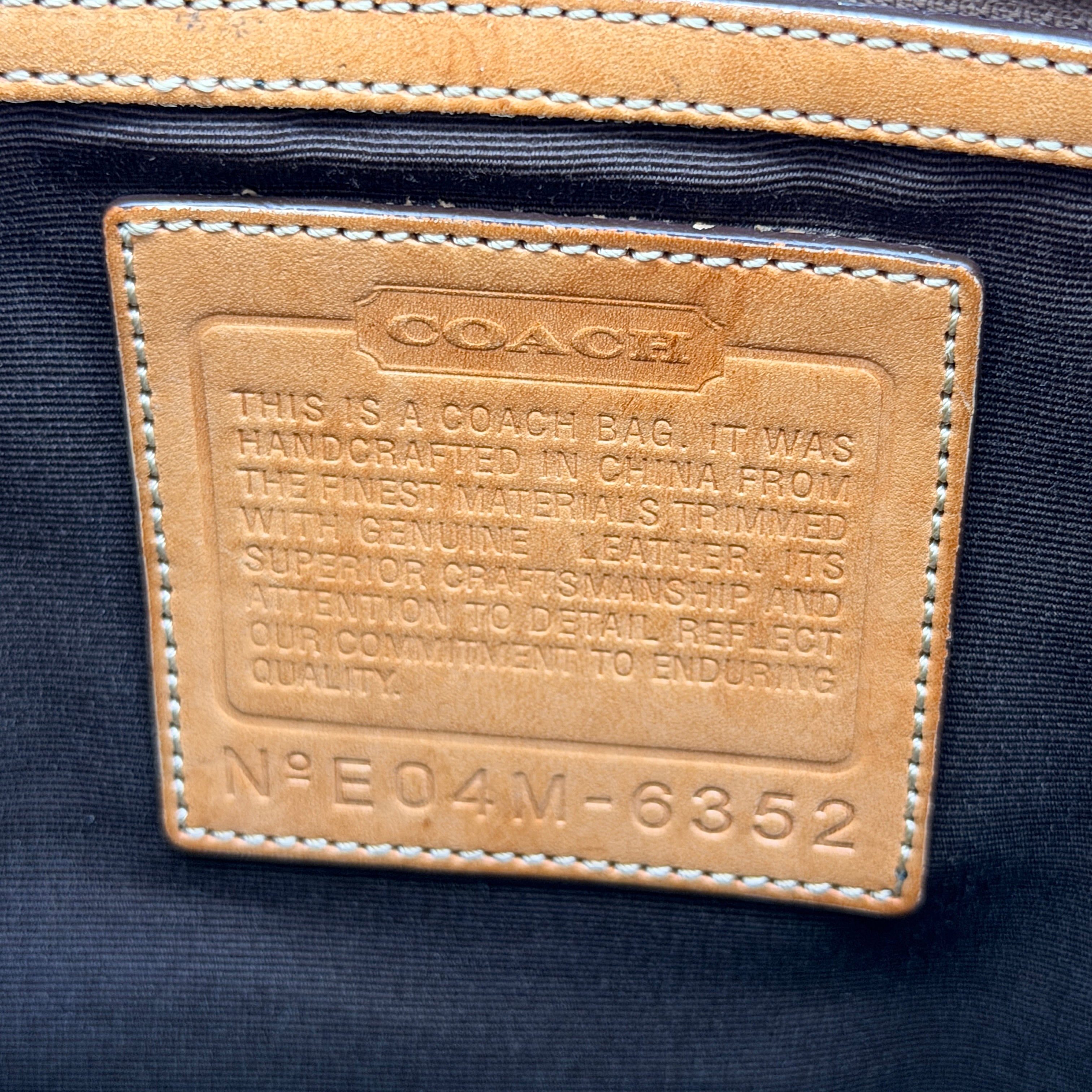 Coach Signature Buckle Tote Bag in beige and tan with signature canvas, tan leather trim, and silver-tone hardware.