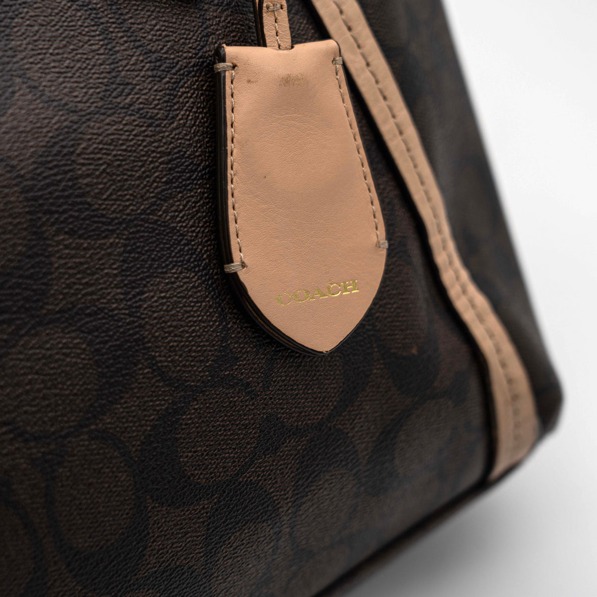 Coach Signature Peyton Pocket tote bag in brown canvas with tan leather trim, shown with both handles and detachable strap.