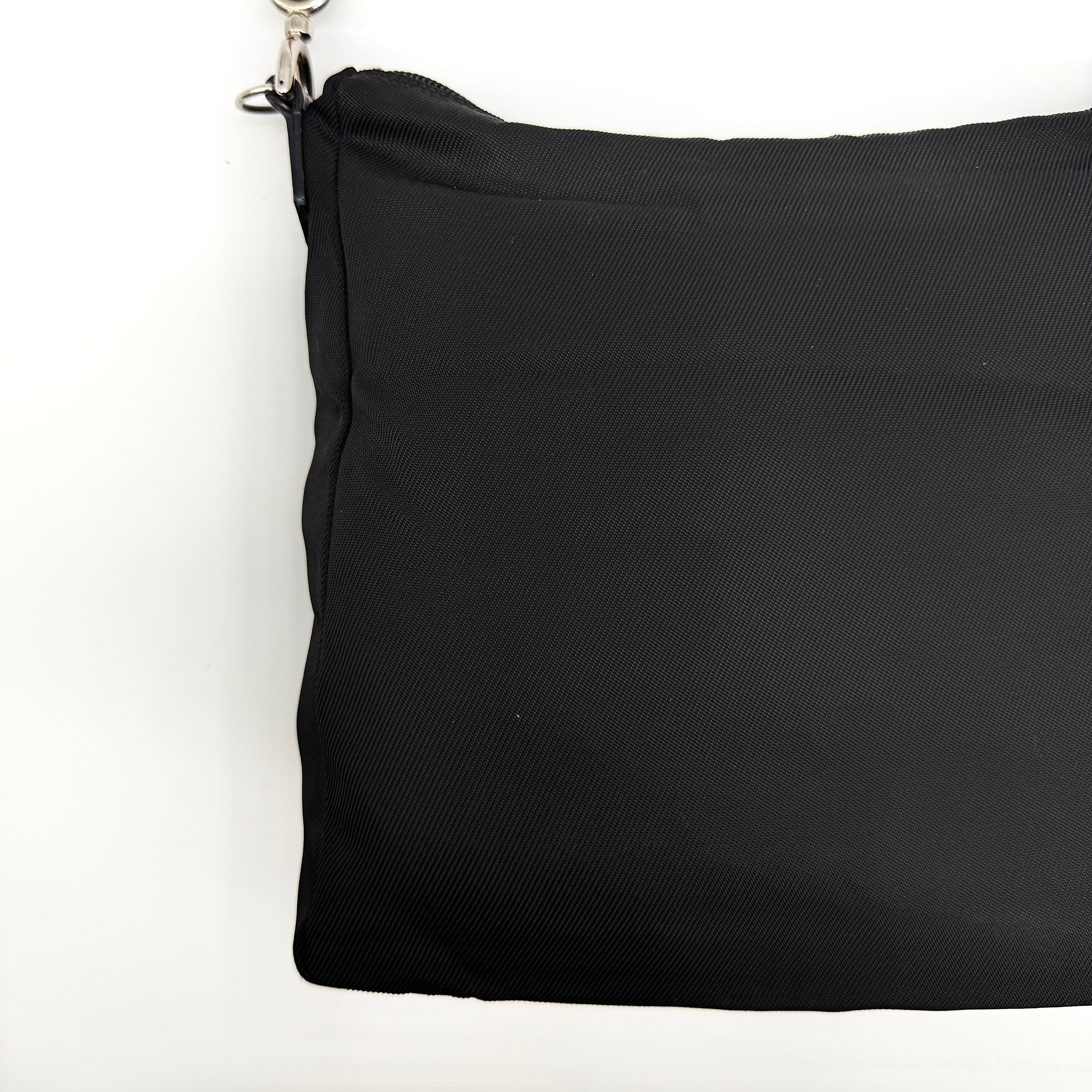Gucci nylon shoulder bag in black with bamboo handle, shown against a white background.