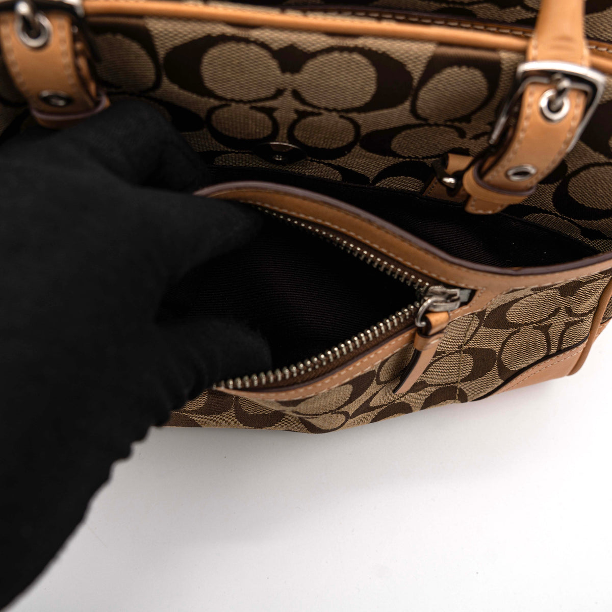 Coach Signature Hampton Satchel Boston Bag in beige and tan canvas with leather trim and silver hardware, styled on a clean background.