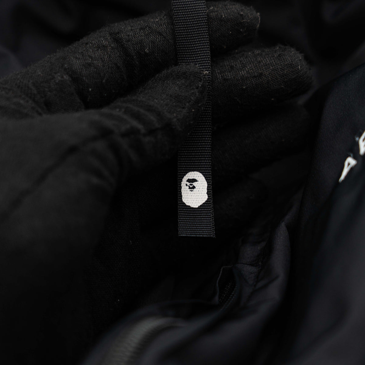 BAPE A Bathing Ape black and white logo track jacket with bold panel detailing, shown laid flat.