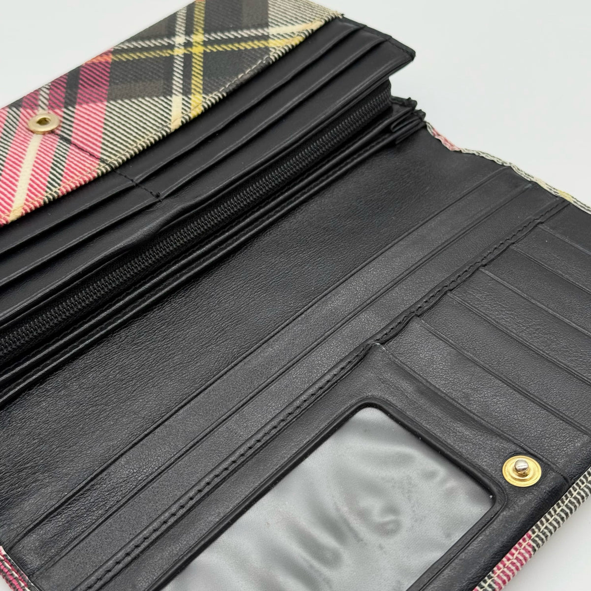 Vivienne Westwood multicolour tartan check long wallet with gold orb logo, shown closed against a white background.