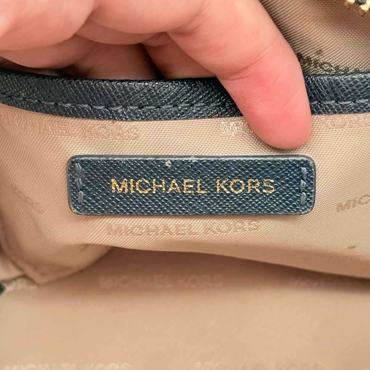 Front view of the Michael Kors black saffiano leather dome cosmetic pouch with gold-tone hardware.
