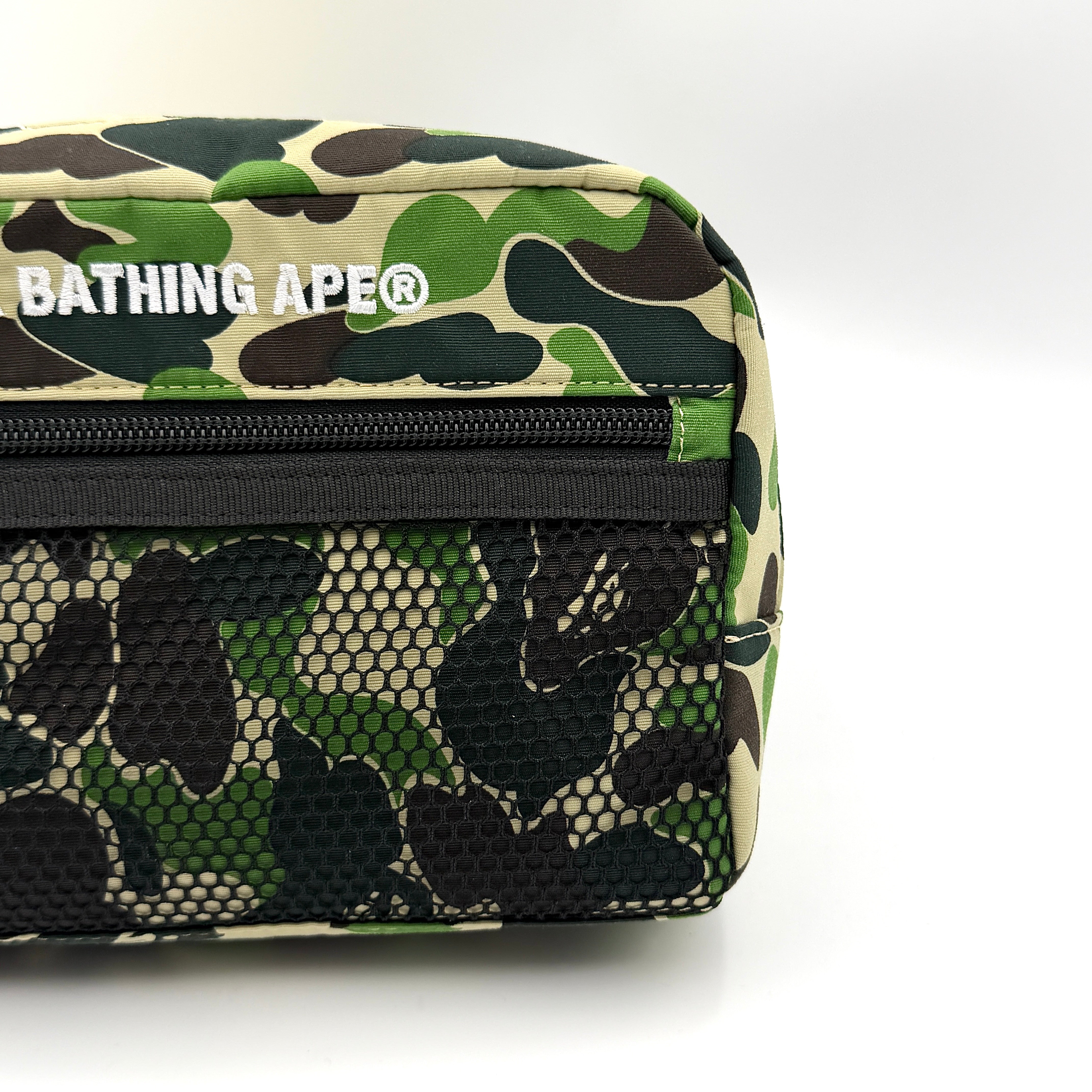 BAPE ABC Camo Pouch in green camouflage with mesh front pocket and embroidered A Bathing Ape logo.
