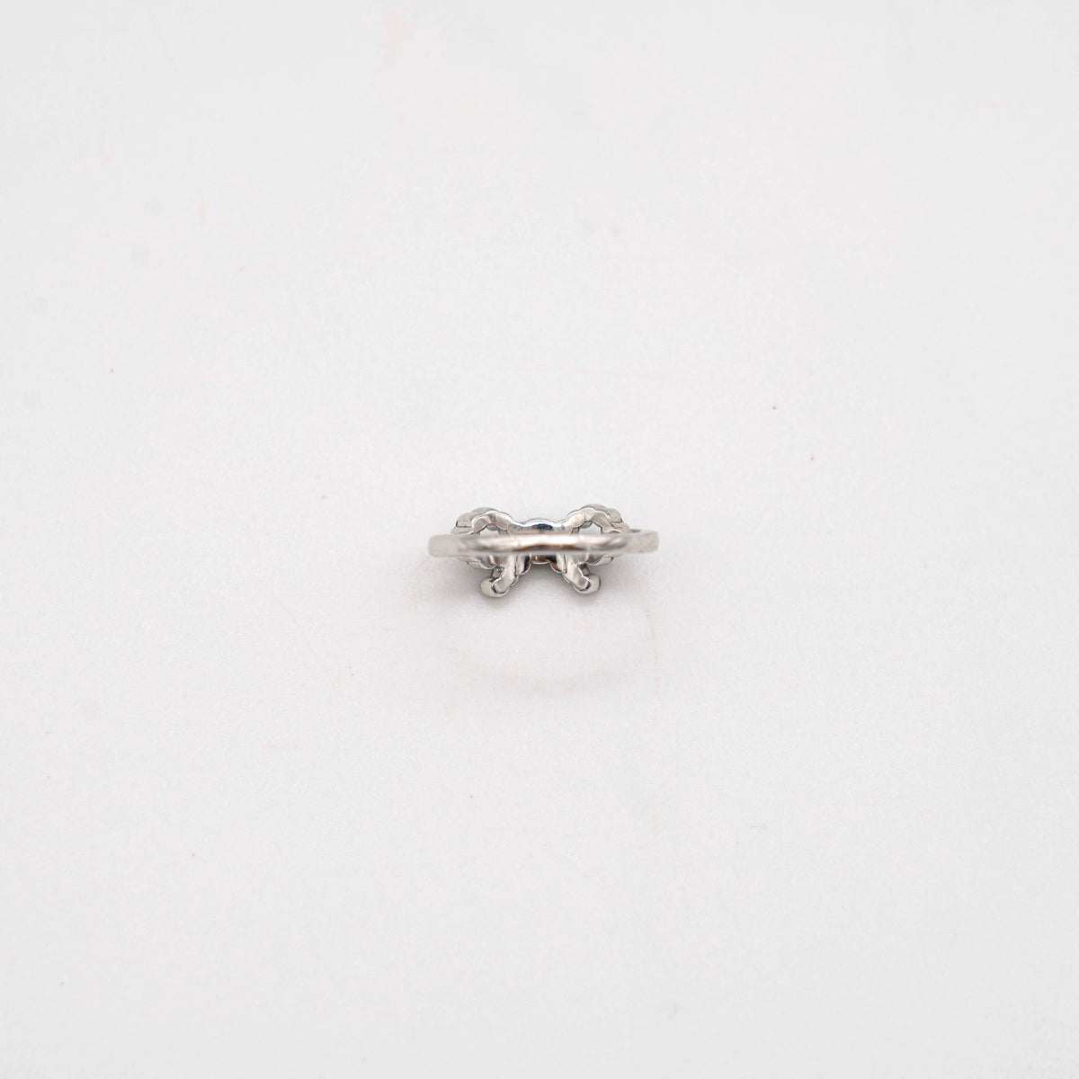 Coach silver ring with a rhinestone-encrusted bow motif, photographed against a white background.