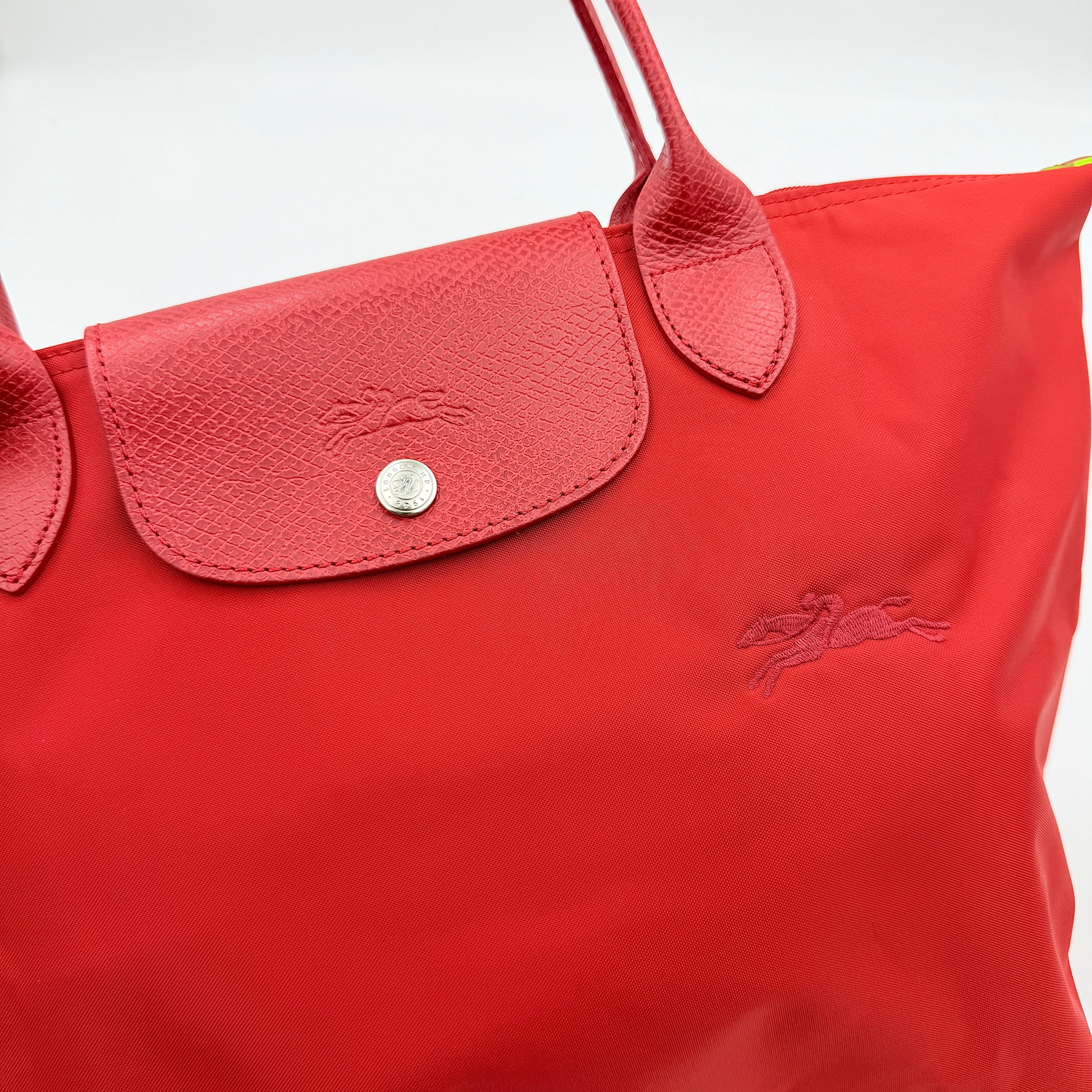 Longchamp Le Pliage Club tote bag in red nylon with tonal leather accents and silver hardware.