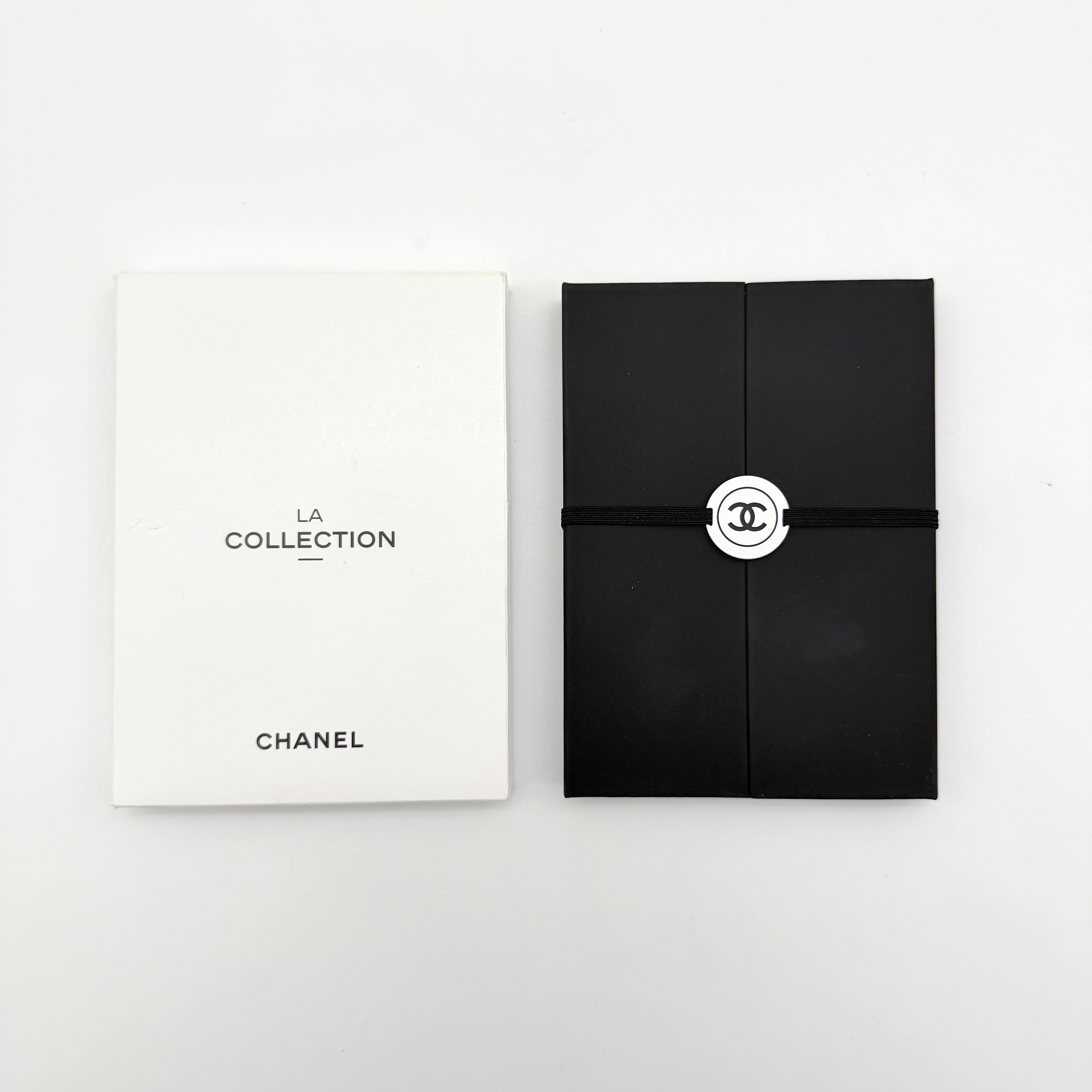 Chanel La Collection Novelty Book Stationary Set with black folder and branded box displayed on a white background