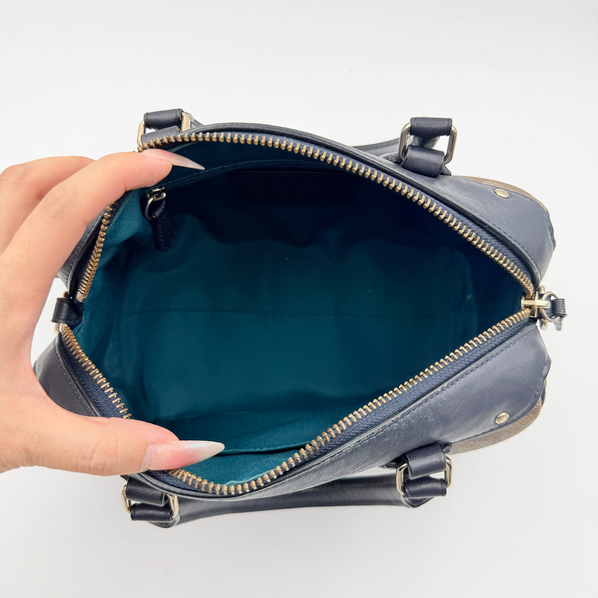 Coach Signature Mini Bennett Boston Bag in monogram canvas with navy and teal varsity stripes and dark navy leather trim.