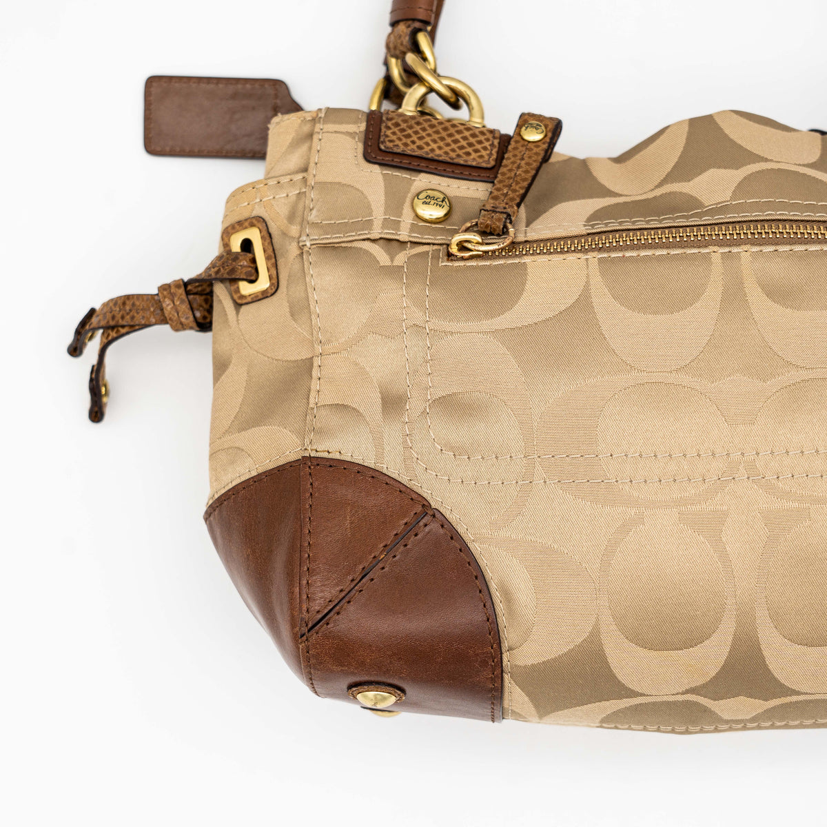 Coach Signature Peyton Shoulder Bag in brown sateen and leather with gold-tone hardware and turnlock pocket, photographed on a white background.