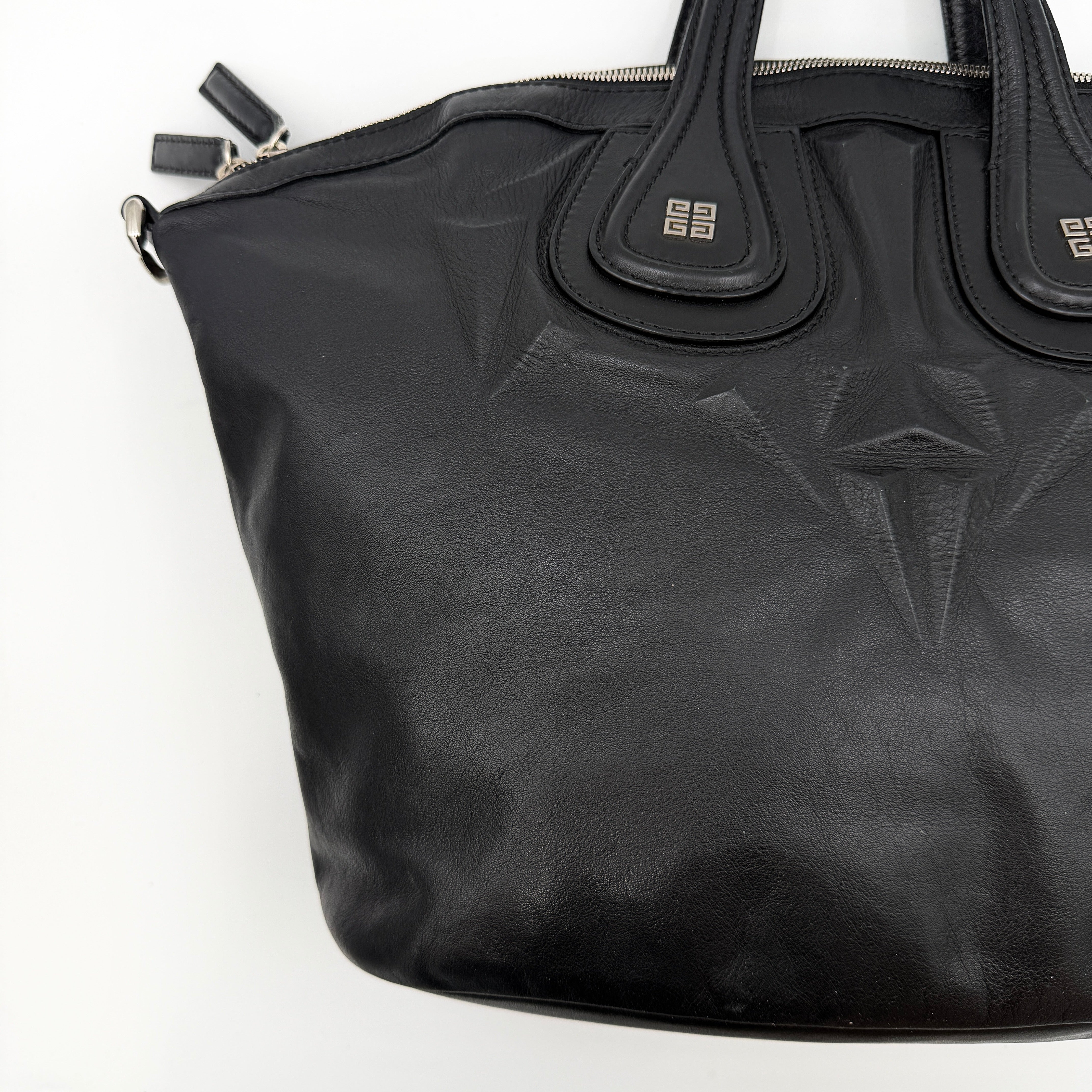 Givenchy 2Way Nightingale Handbag in black leather with detachable strap and striking front motif.