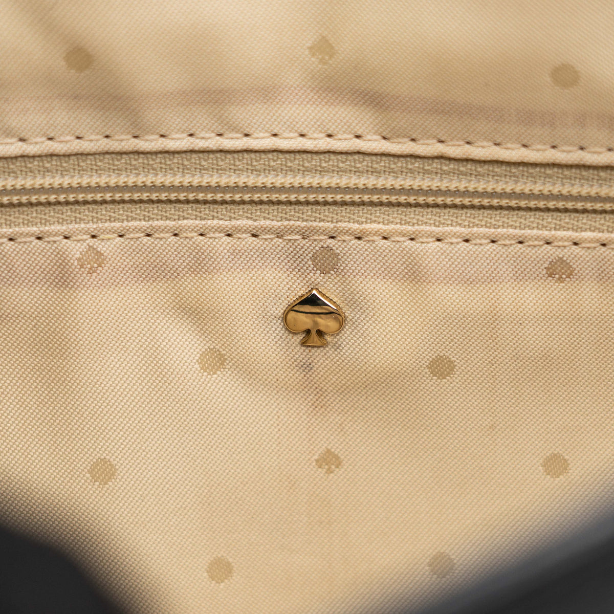 Kate Spade New York black leather shoulder bag with gold chain strap and bow detail, displayed against a white background.