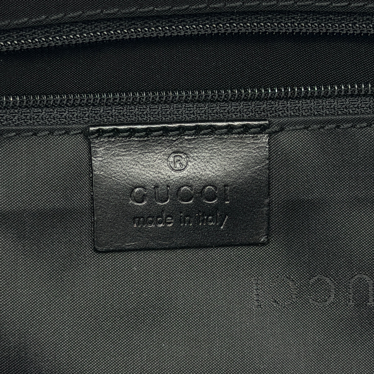 Gucci black nylon shoulder bag with bamboo handle and detachable strap shown with dust bag.
