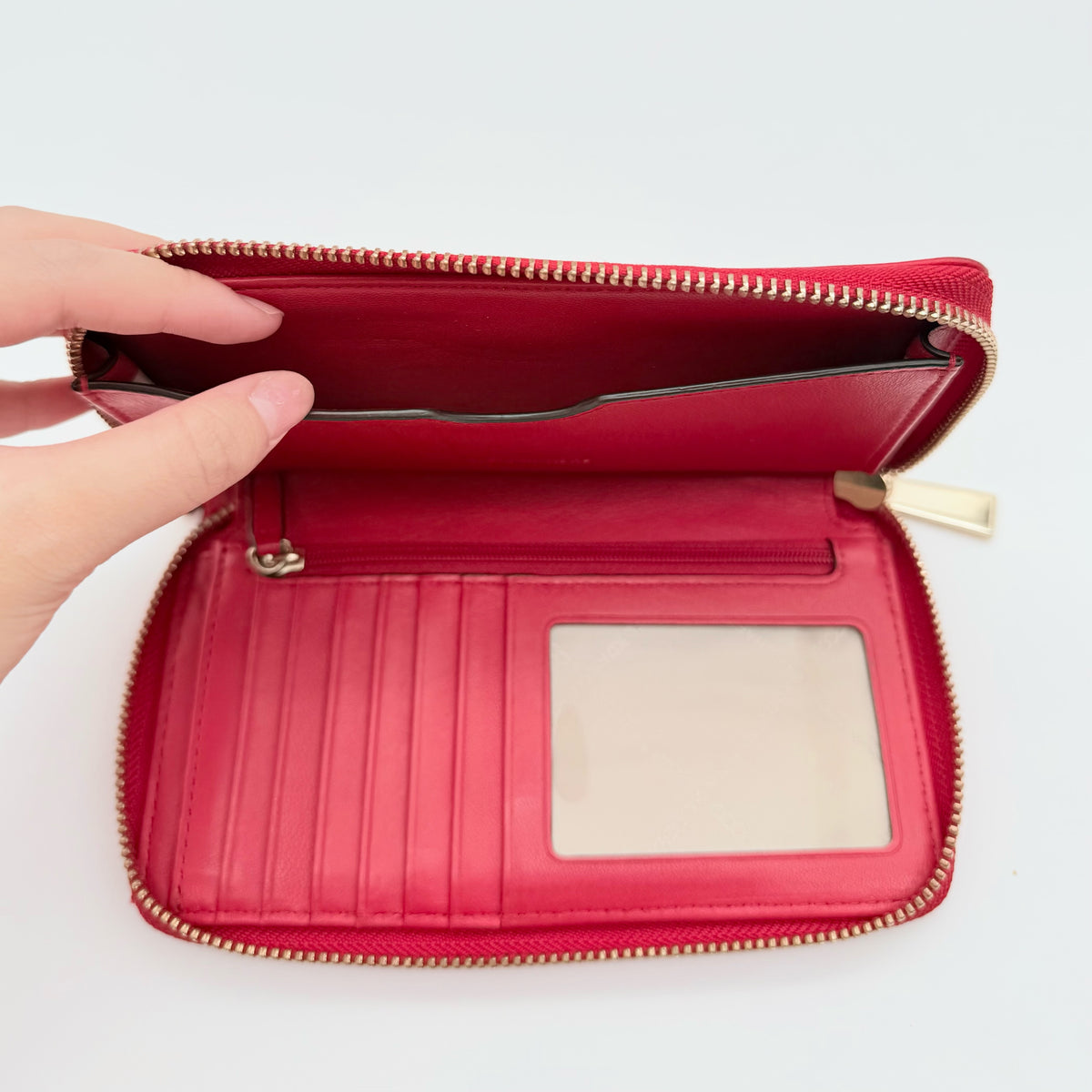 Front view of the Michael Kors red quilted large wallet with gold zip and MK monogram stitching.