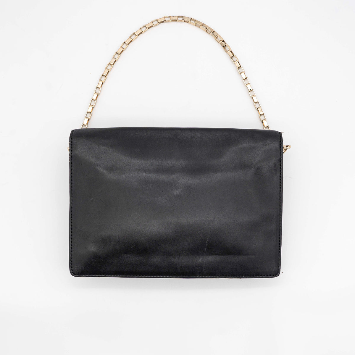 Kate Spade New York black leather shoulder bag with gold chain strap and bow detail, displayed against a white background.