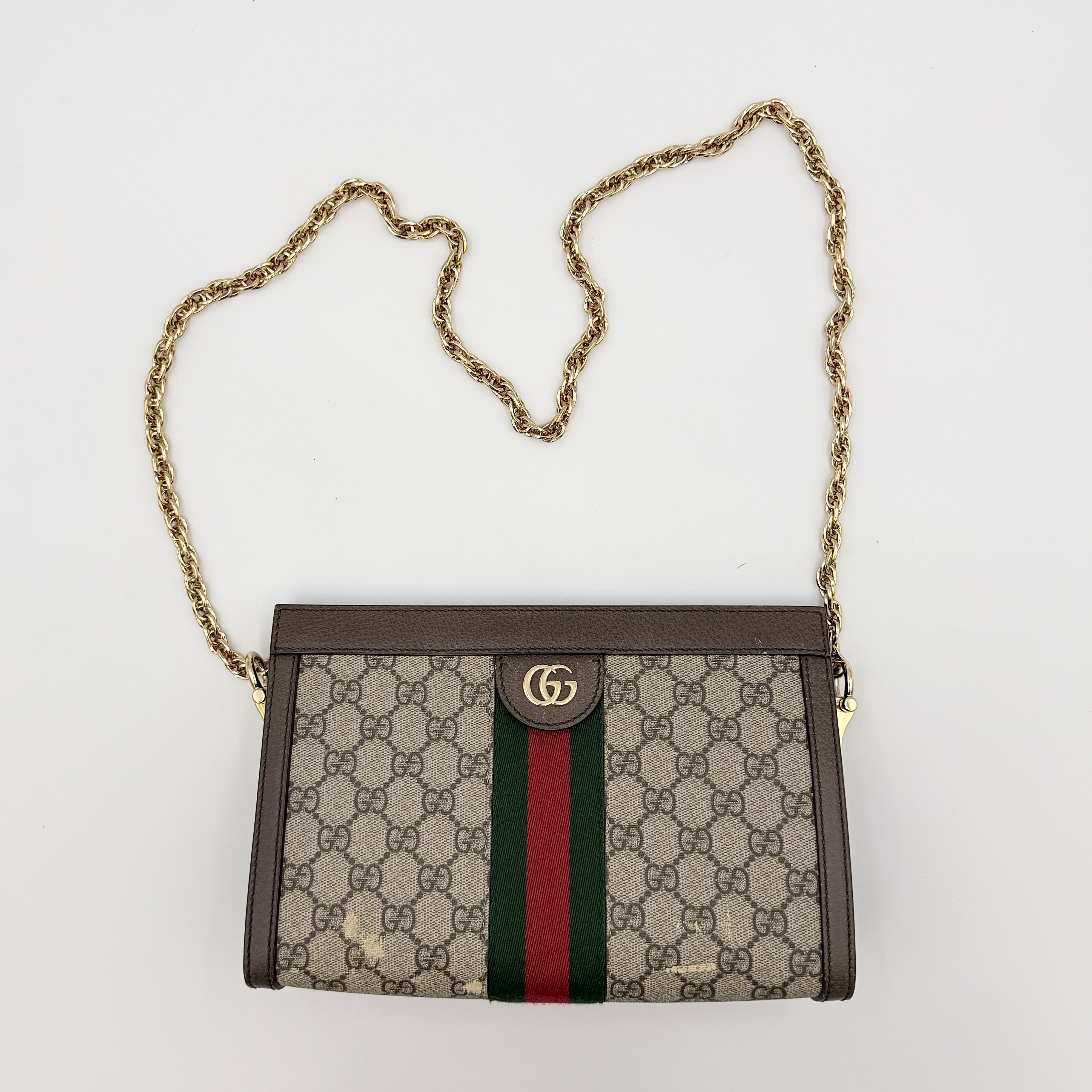 Gucci Ophidia GG Supreme crossbody bag in beige canvas with brown leather trim, signature web stripe, and gold chain strap.