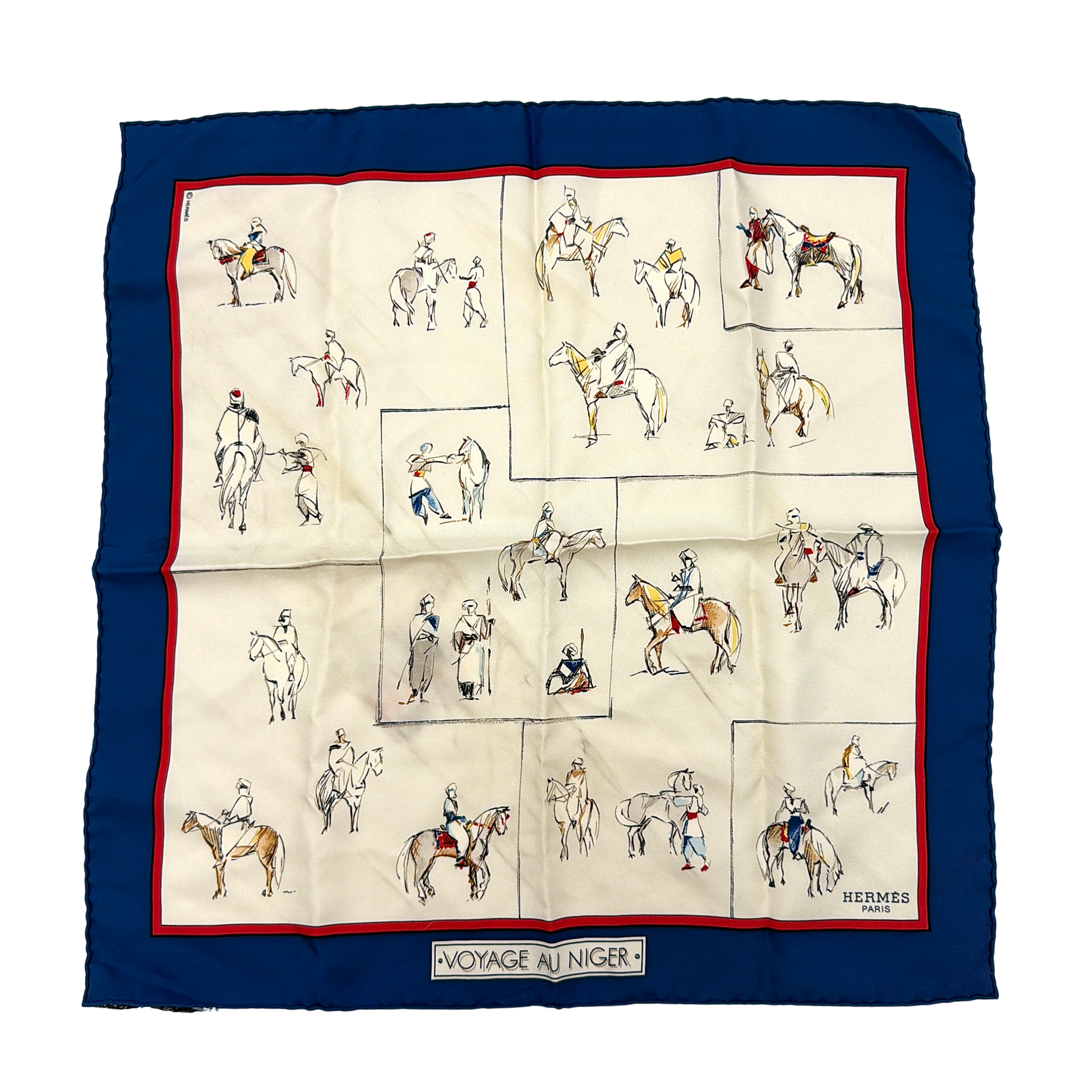 Hermès Voyage au Niger silk scarf in navy blue with cream center, featuring illustrative equestrian sketches bordered in red.