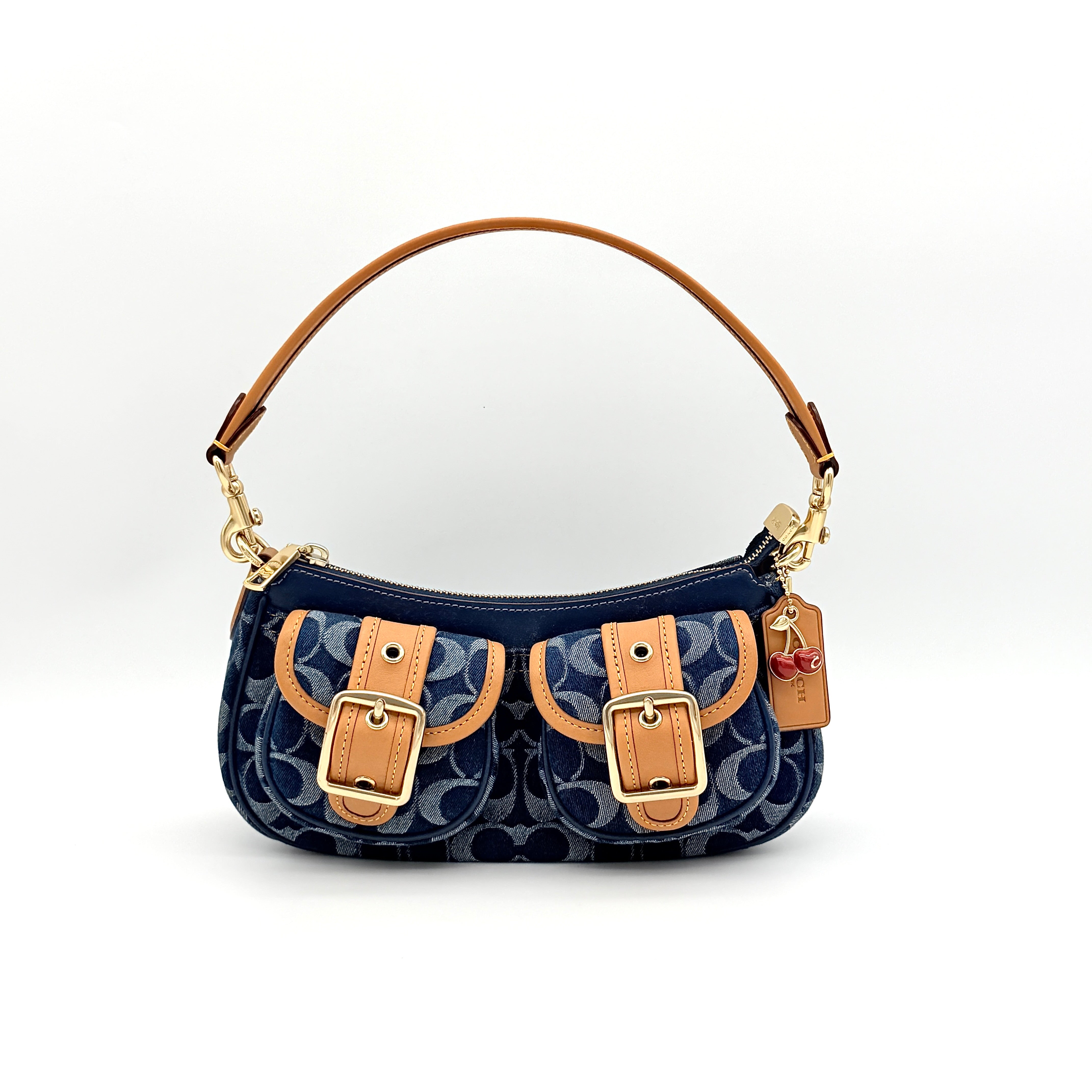 Coach Signature Ashton shoulder bag in blue denim and tan leather with gold hardware, shown with removable strap and dust bag.