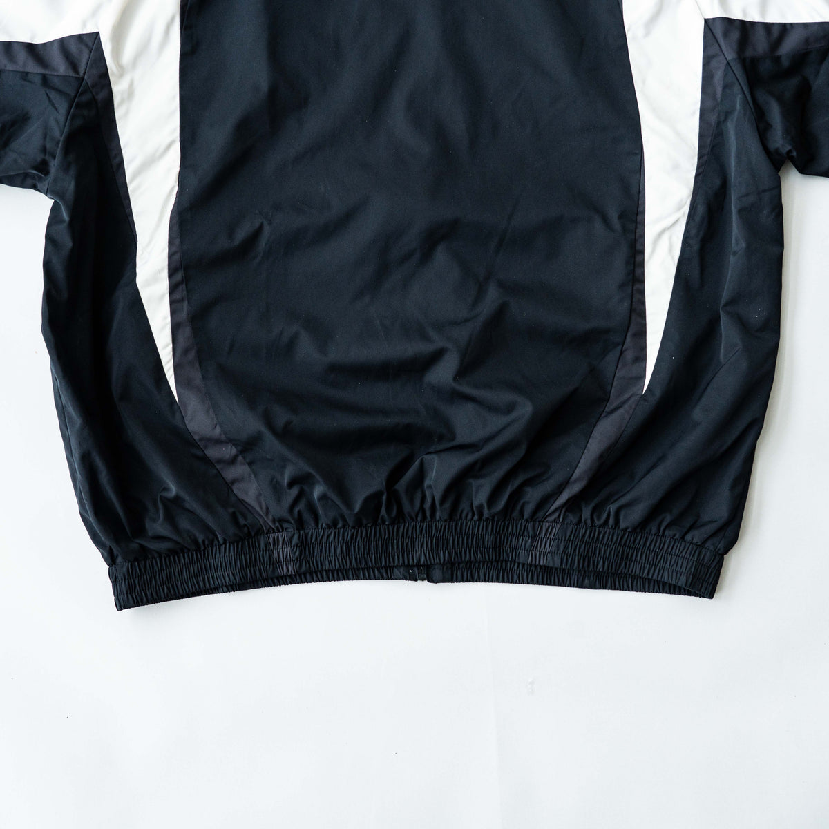 BAPE A Bathing Ape black and white logo track jacket with bold panel detailing, shown laid flat.