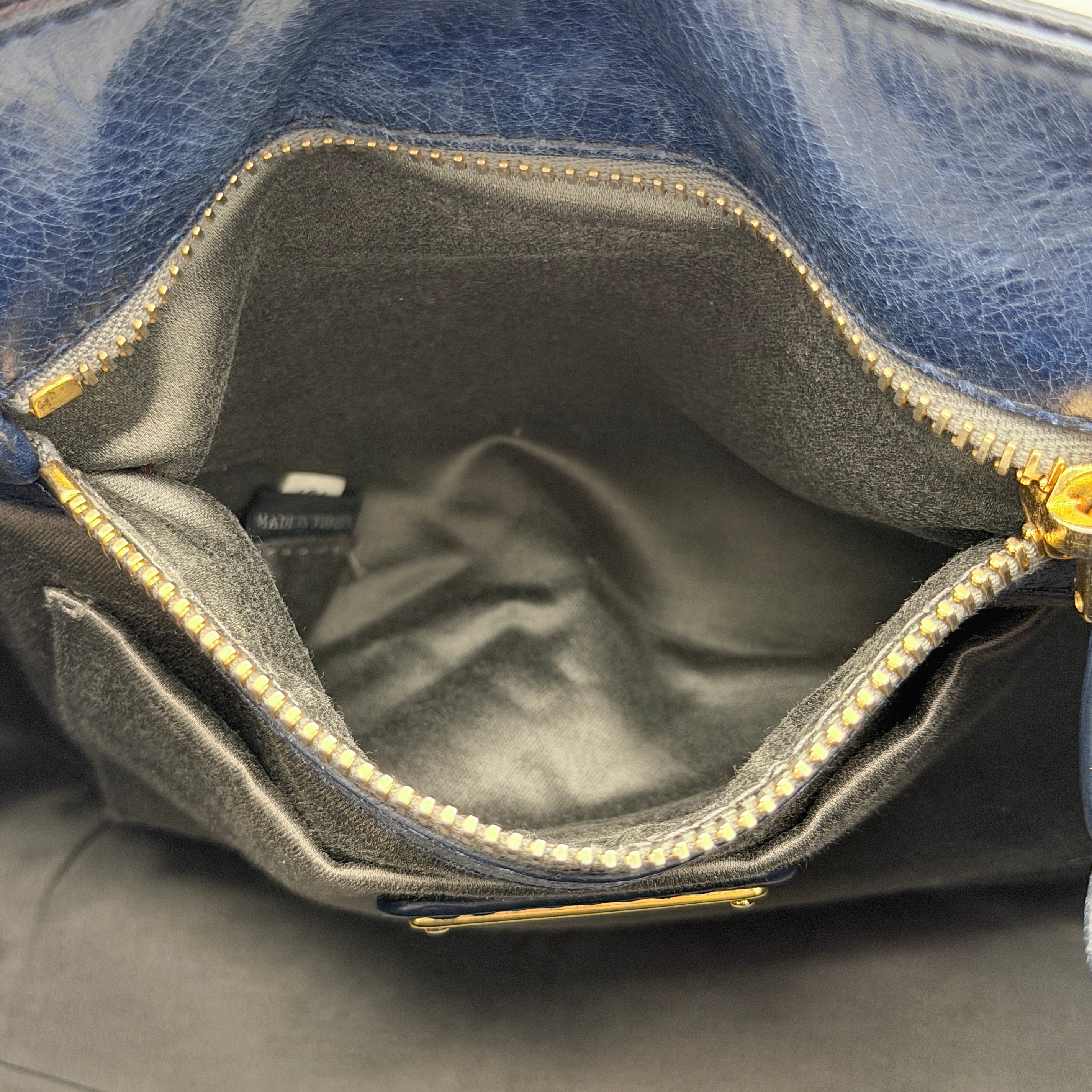 Miu Miu navy blue Vitello Lux Bow Satchel with gold-tone hardware, detachable strap, and dust bag.