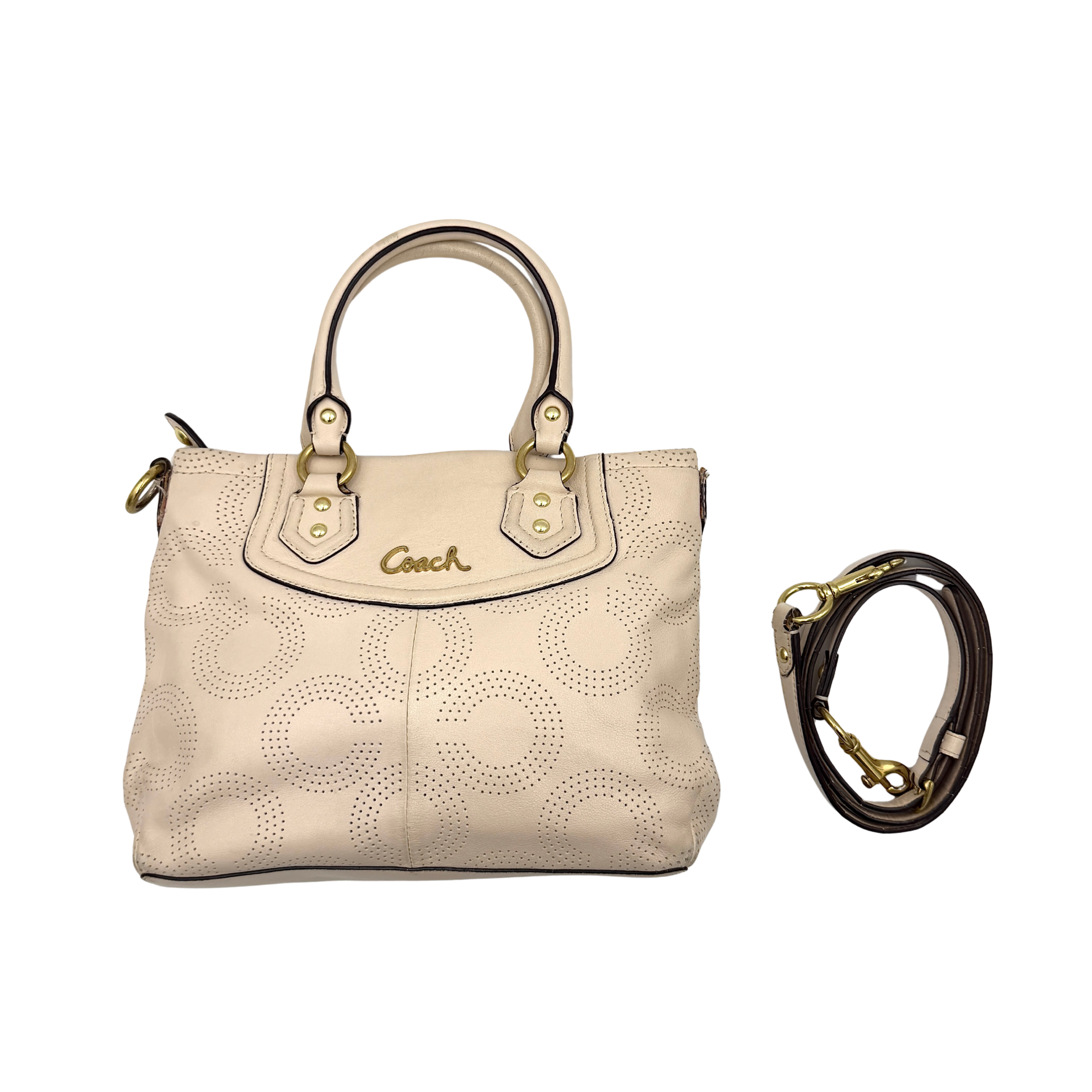 Coach Ashley 2Way cream perforated Op Art leather handbag with dual handles and detachable strap, styled on a white background.