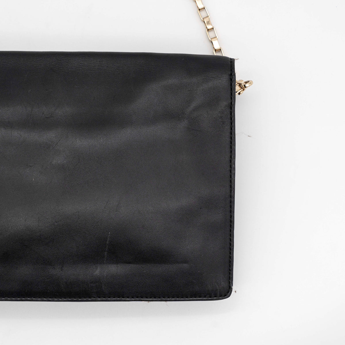 Kate Spade New York black leather shoulder bag with gold chain strap and bow detail, displayed against a white background.