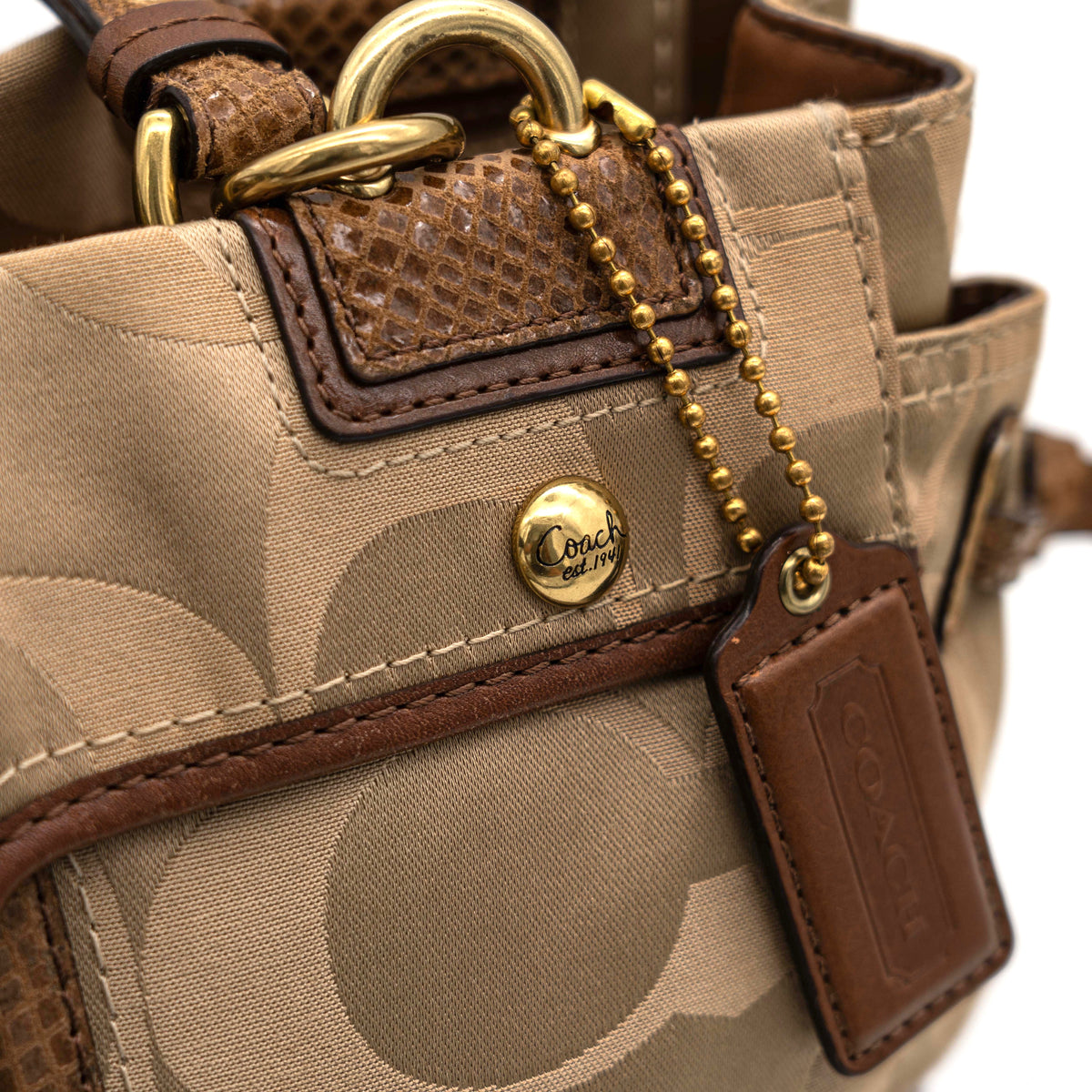 Coach Signature Peyton Shoulder Bag in brown sateen and leather with gold-tone hardware and turnlock pocket, photographed on a white background.