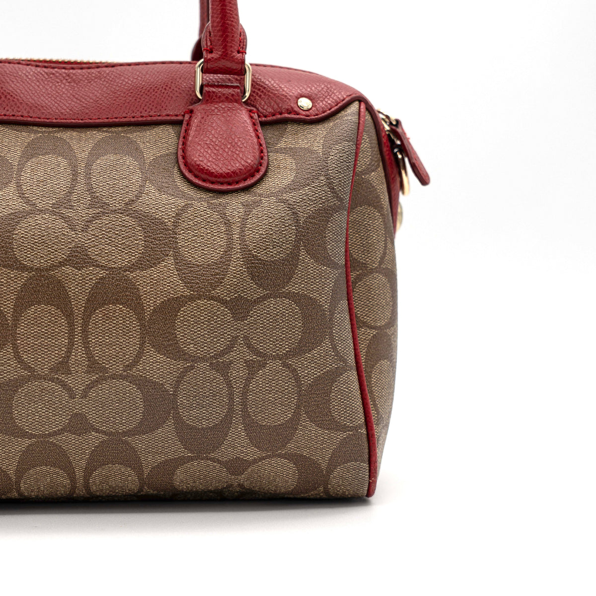 Coach Mini Bennett Boston bag in signature beige canvas with red leather trim, shown with detachable crossbody strap.