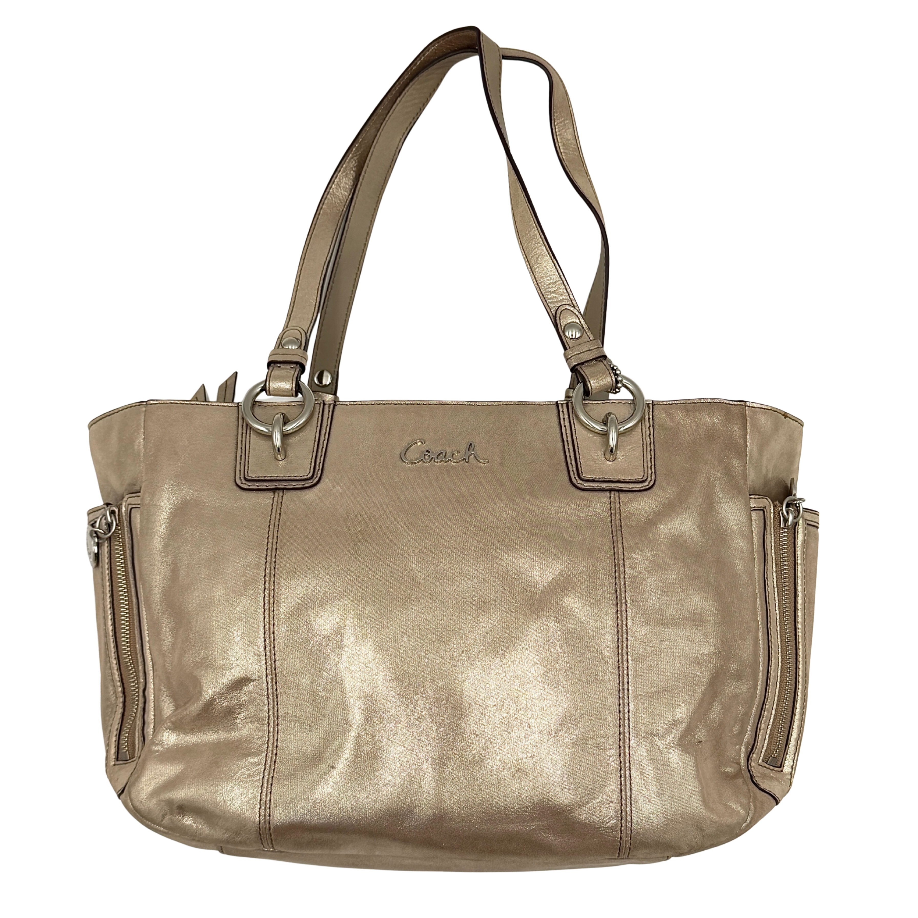 Coach Shimmer Gallery Tote in metallic beige leather with silver-tone hardware and dual top handles, set against a white background.