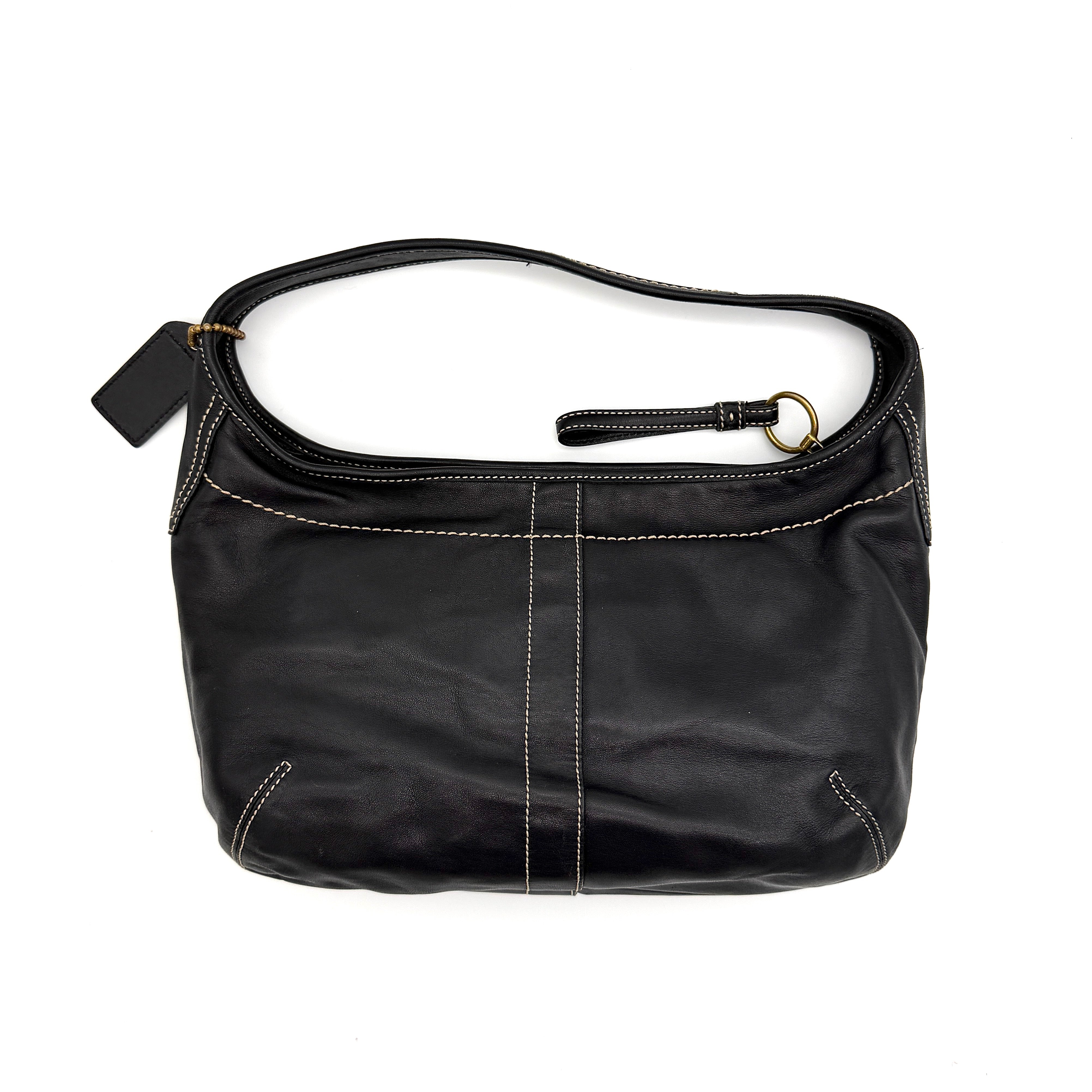 Coach Signature Ergo Hobo Shoulder Bag in black leather with contrast stitching and brass hardware, displayed against a white background.