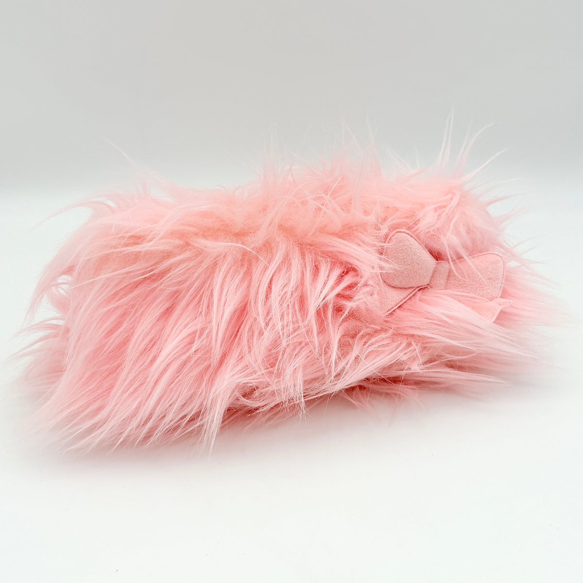 Gentle Monster x Jennie Hush W2 oval sunglasses in white with a pink bow charm, styled with the signature pink furry case.