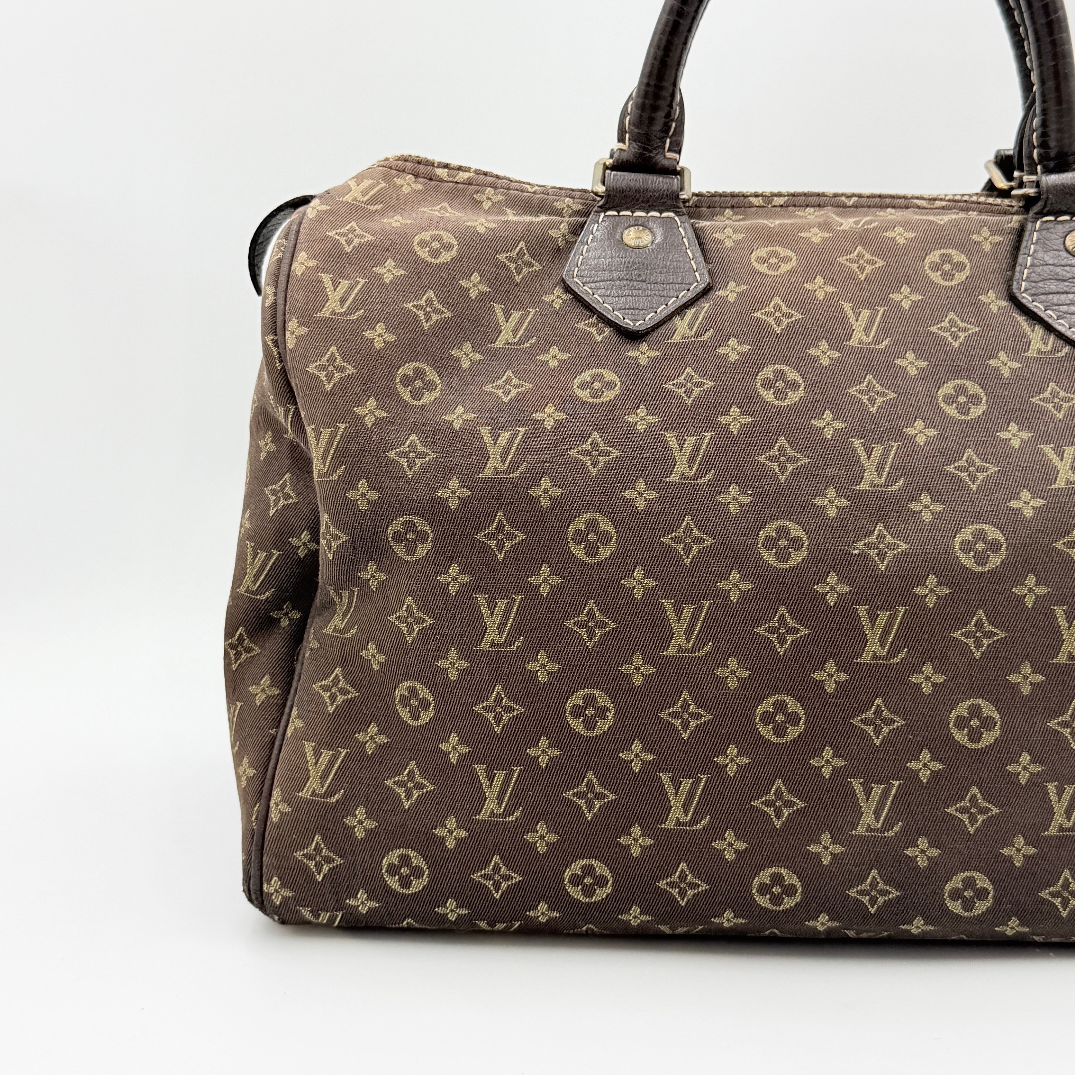 Louis Vuitton Monogram Mini Lin Speedy 30 in brown textile with top handles and monogram motif, shown against a white background.