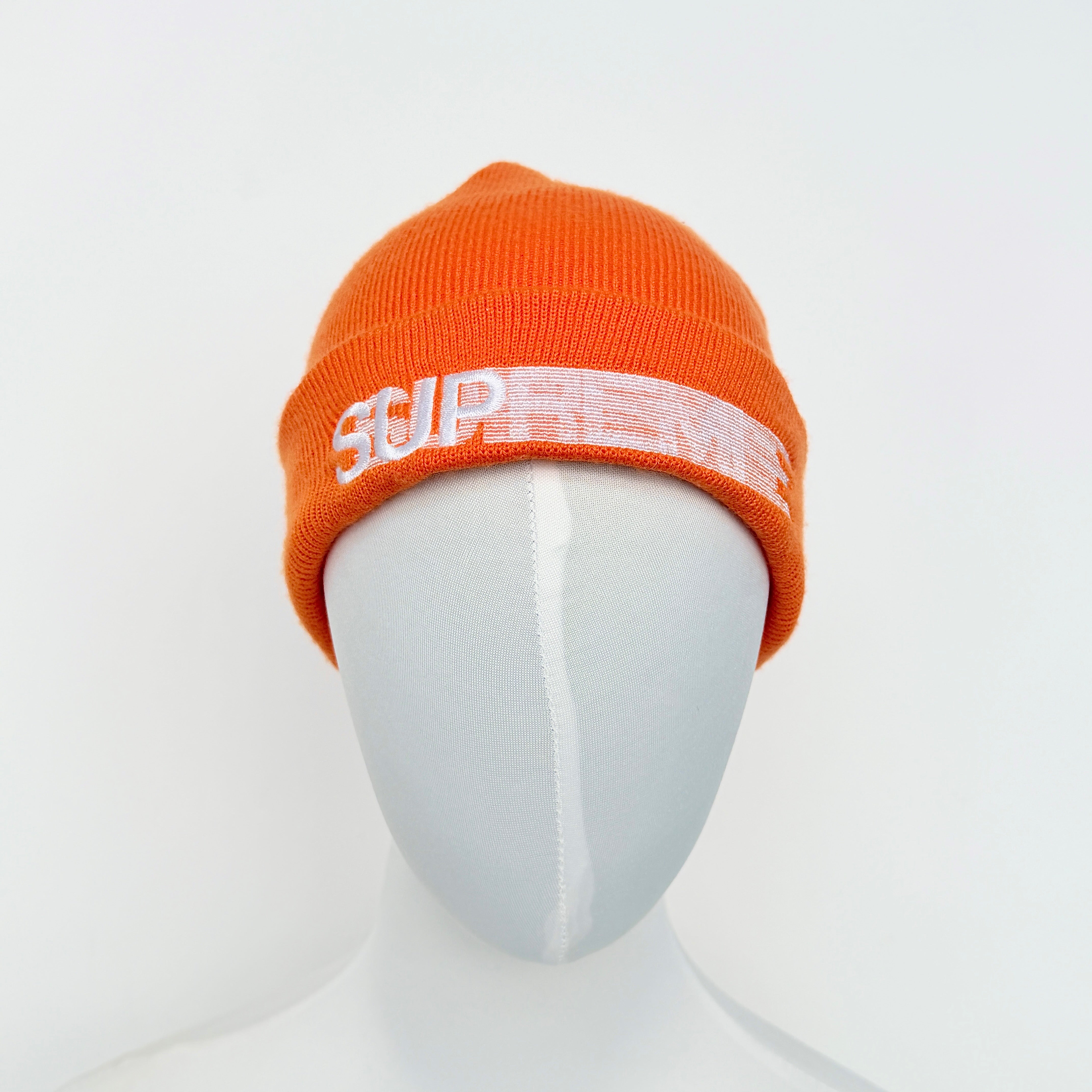 Supreme Motion Logo Beanie in orange with white embroidered logo across the front cuff.