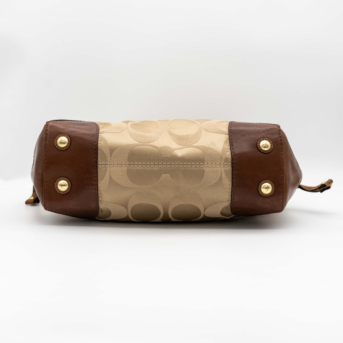 Coach Signature Peyton Shoulder Bag in brown sateen and leather with gold-tone hardware and turnlock pocket, photographed on a white background.