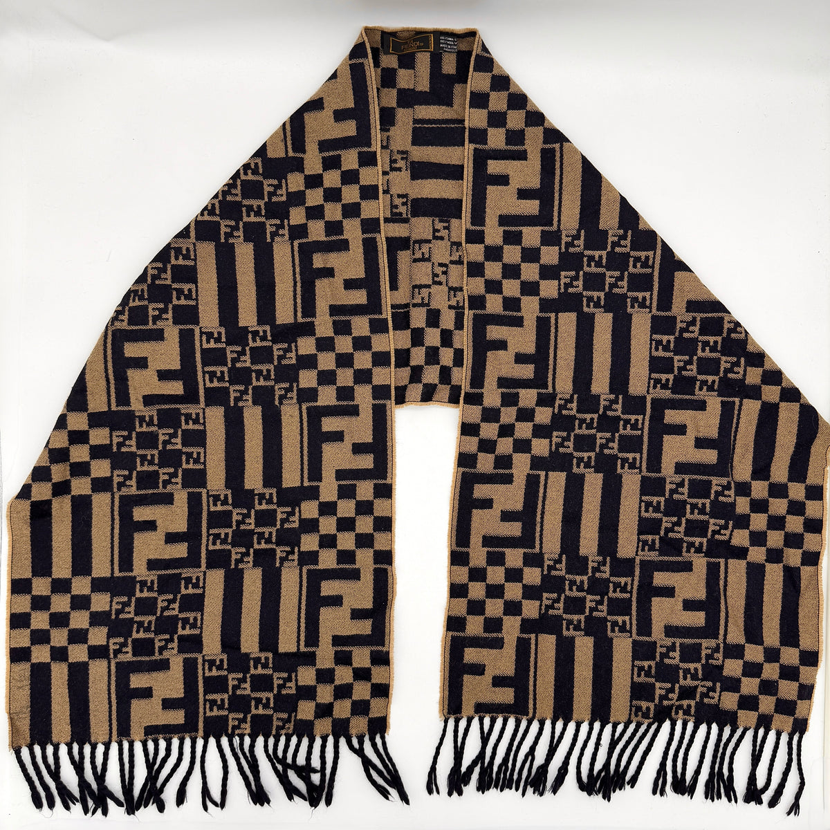 Fendi FF Zucca scarf in beige and black wool with checkered pattern and fringed edges, displayed flat.
