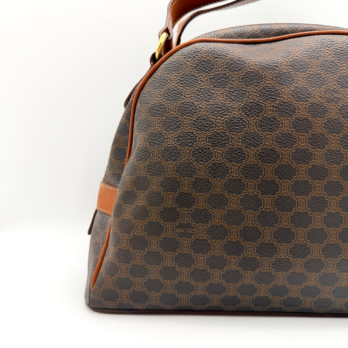 Front view of the Celine Triomphe Macadam Dome Handbag in brown, featuring the signature monogram canvas and tan leather details.