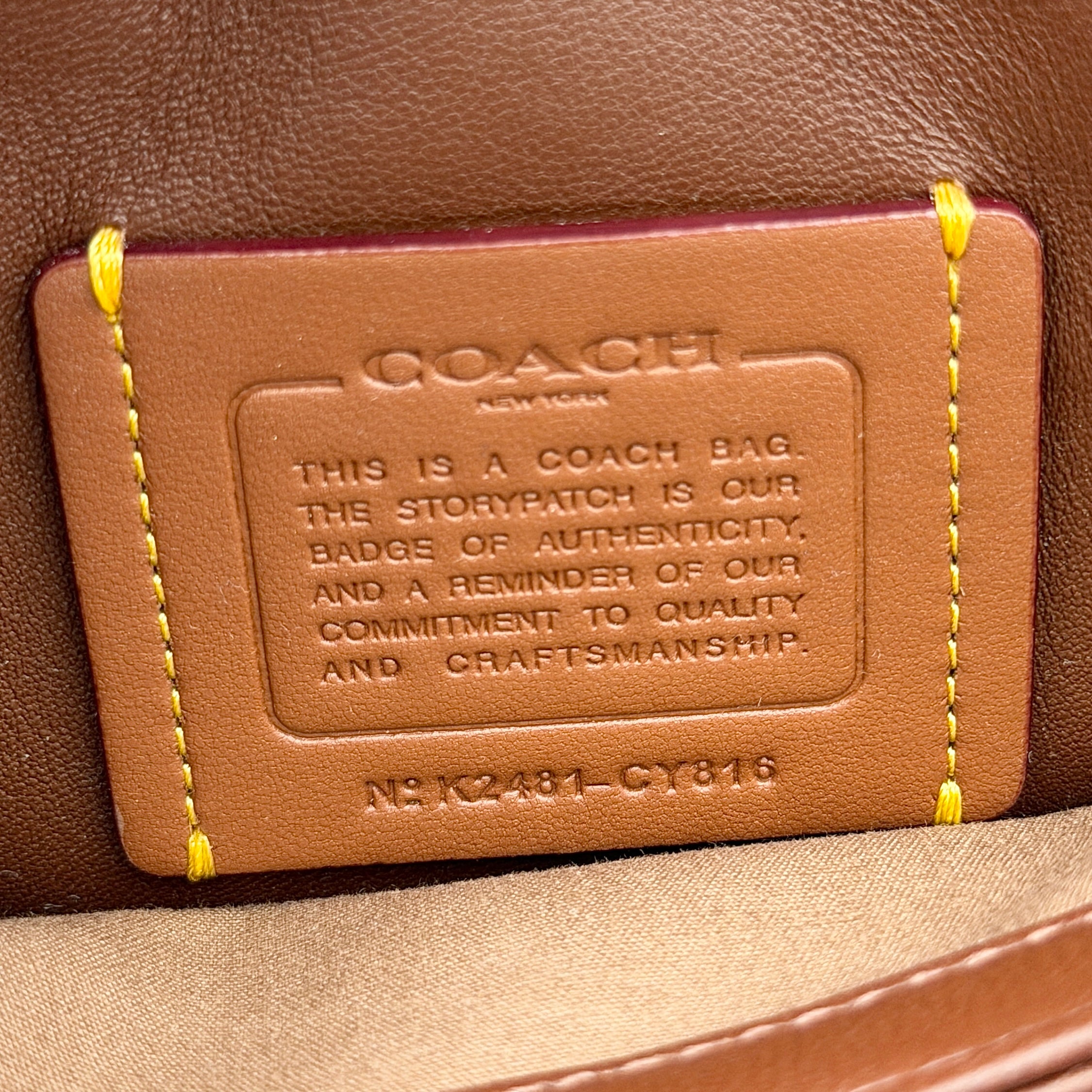 Coach Signature Quilted Tabby Shoulder Bag in brown monogram canvas with gold chain strap and oversized C clasp.