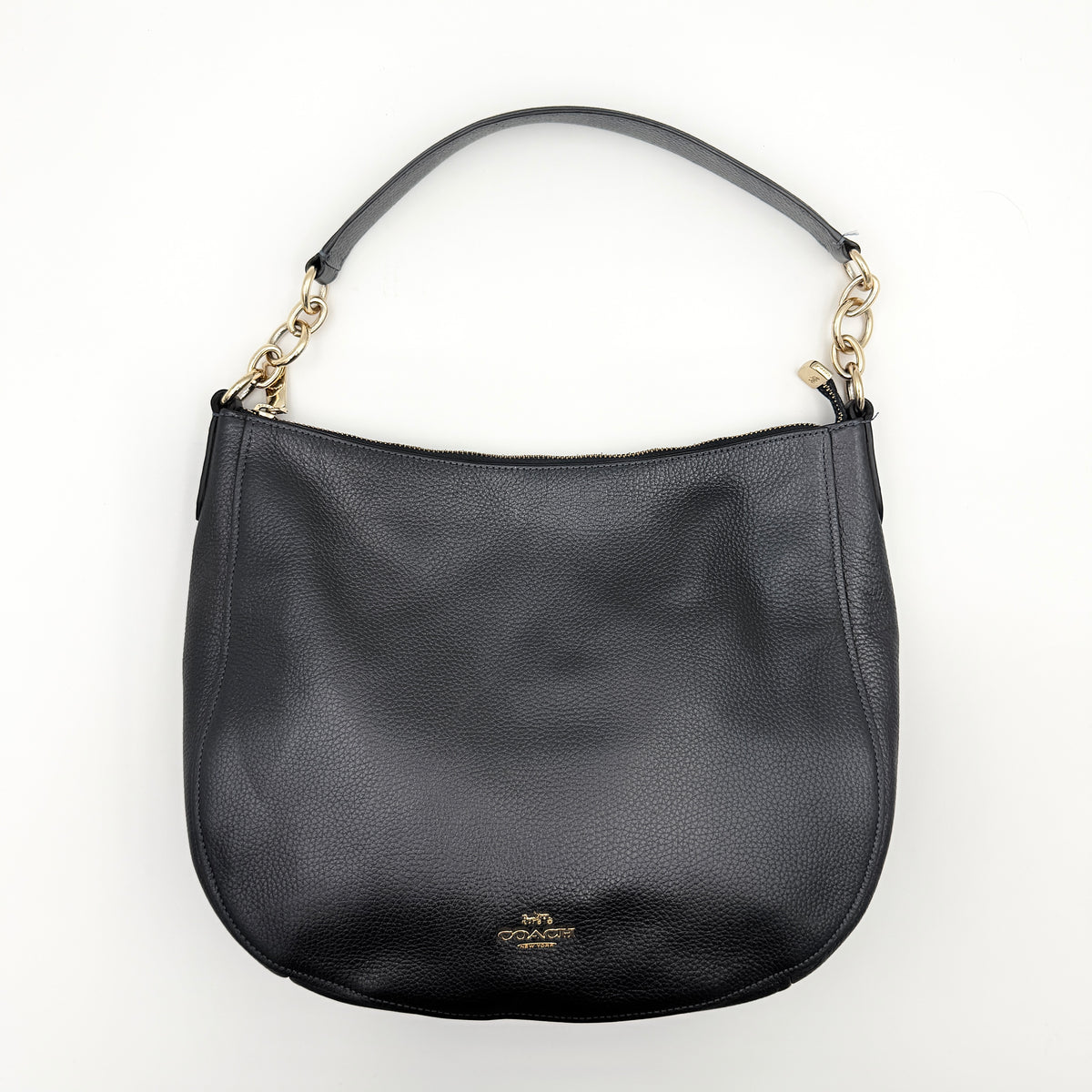 Coach Elle Hobo bag in navy blue pebbled leather with gold hardware and a detachable strap, styled on a white background.