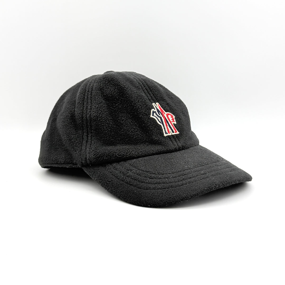 Moncler Grenoble black fleece baseball cap with tri-colour logo patch on the front and tonal embroidery details.