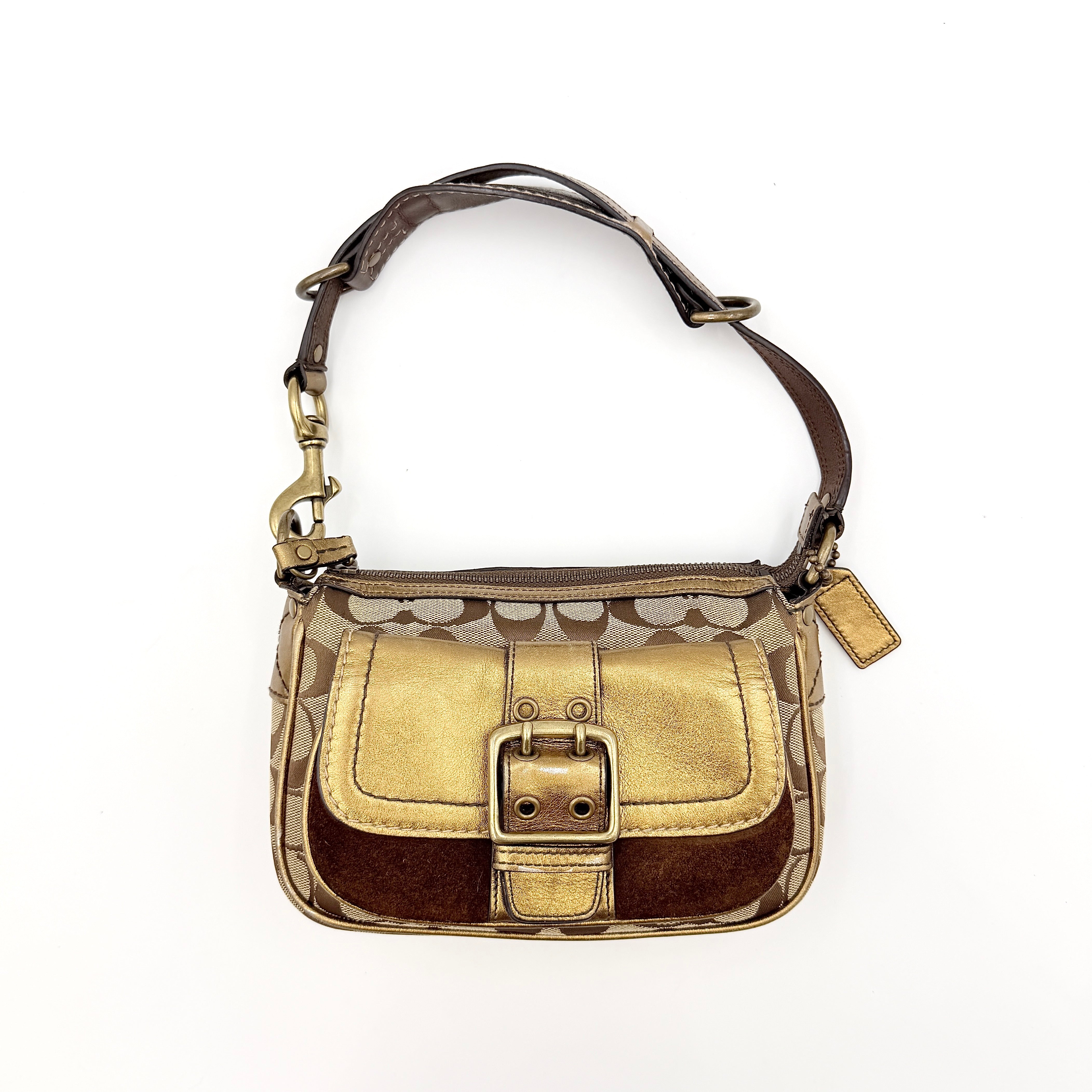 Coach Signature shoulder bag in beige jacquard with gold leather front flap, showcased on a plain background.
