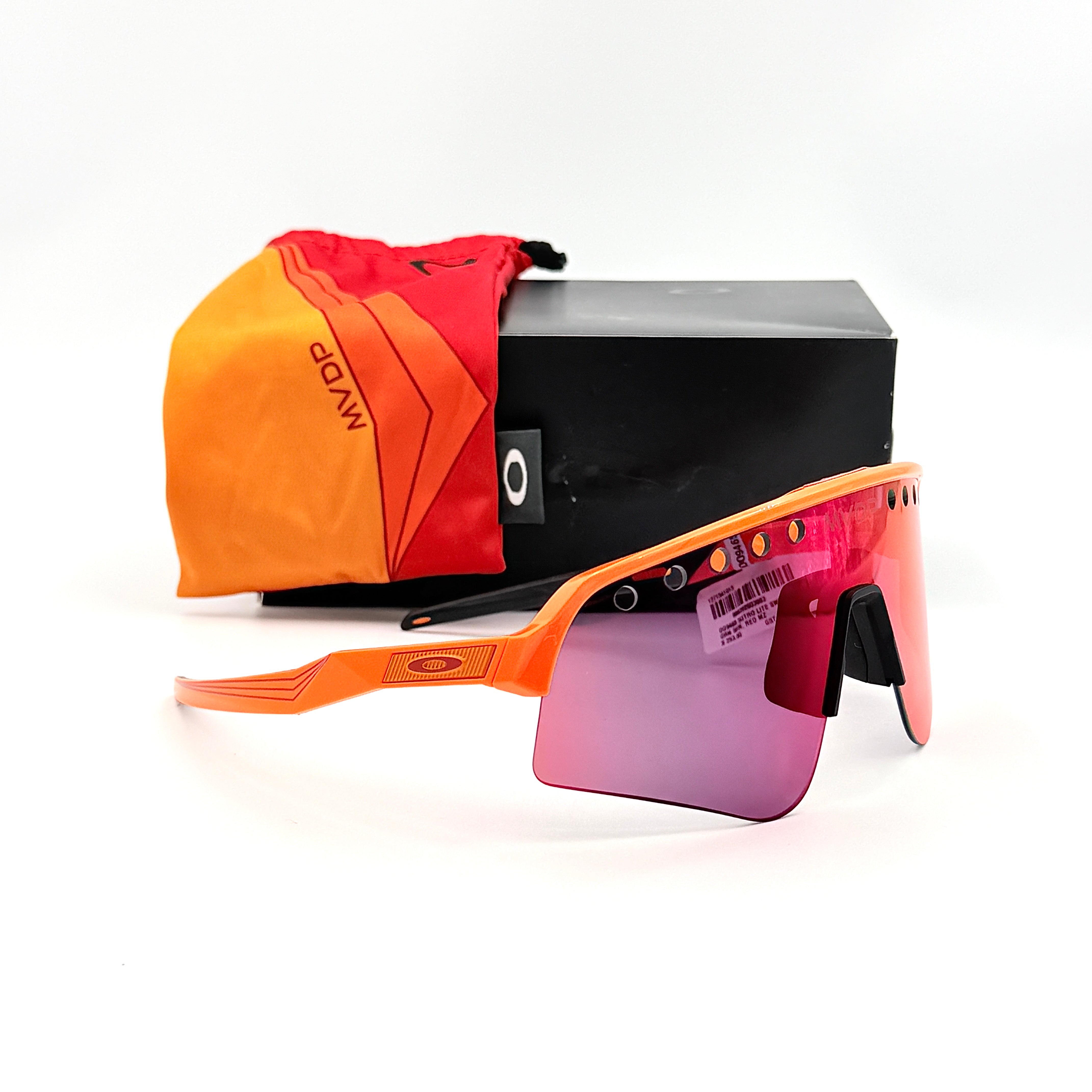 Oakley Sutro Lite Sweep MVDP Prizm Road sunglasses in orange sparkle with a shield lens and original pouch, photographed in bright studio lighting.