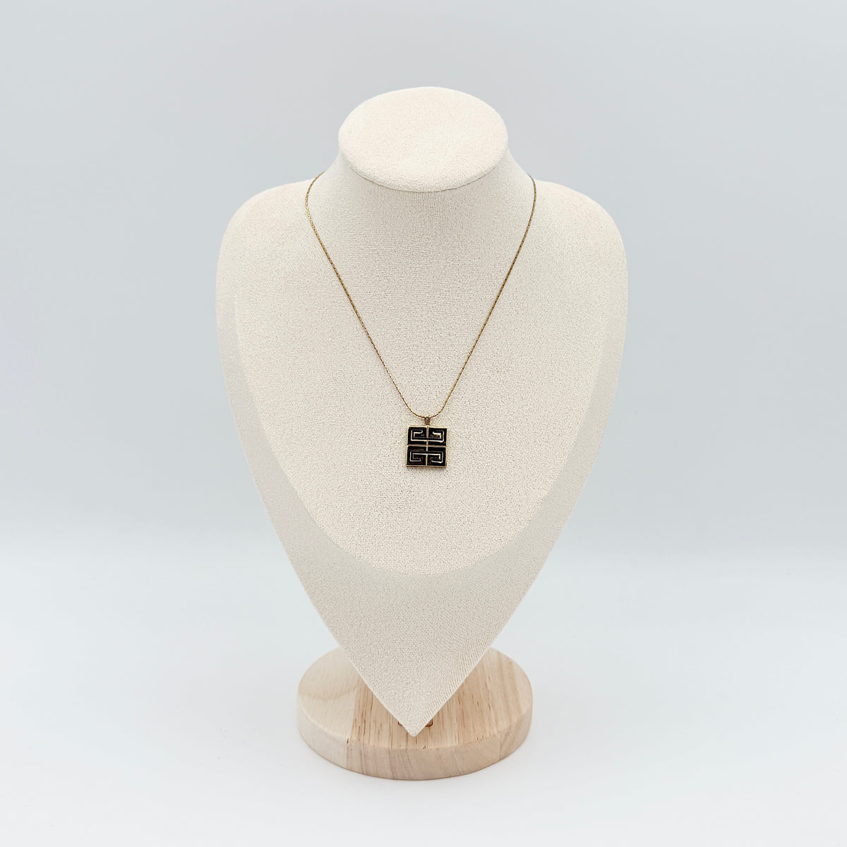Givenchy 4G Logo Necklace in polished gold-tone metal with a geometric pendant on a fine chain.