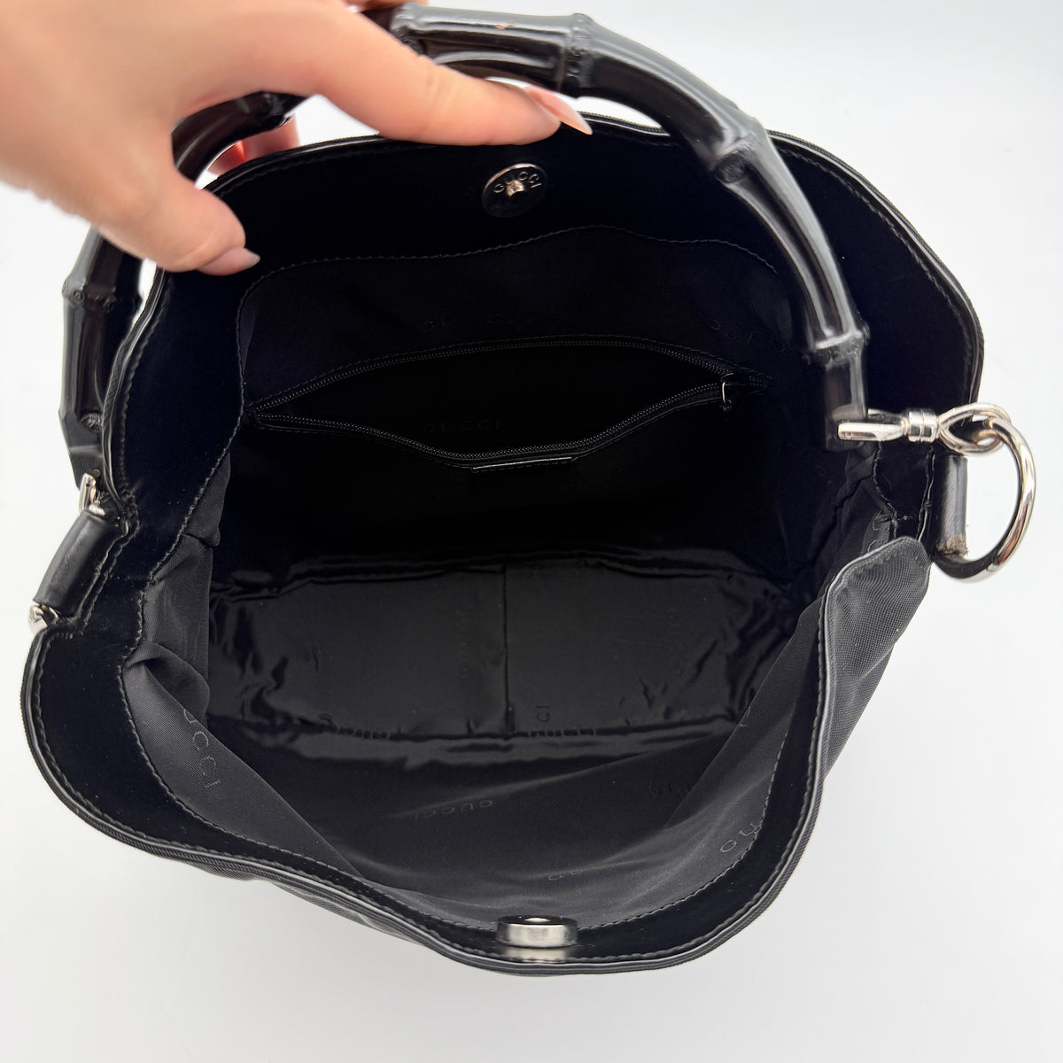 Gucci black nylon shoulder bag with bamboo handle and detachable strap shown with dust bag.