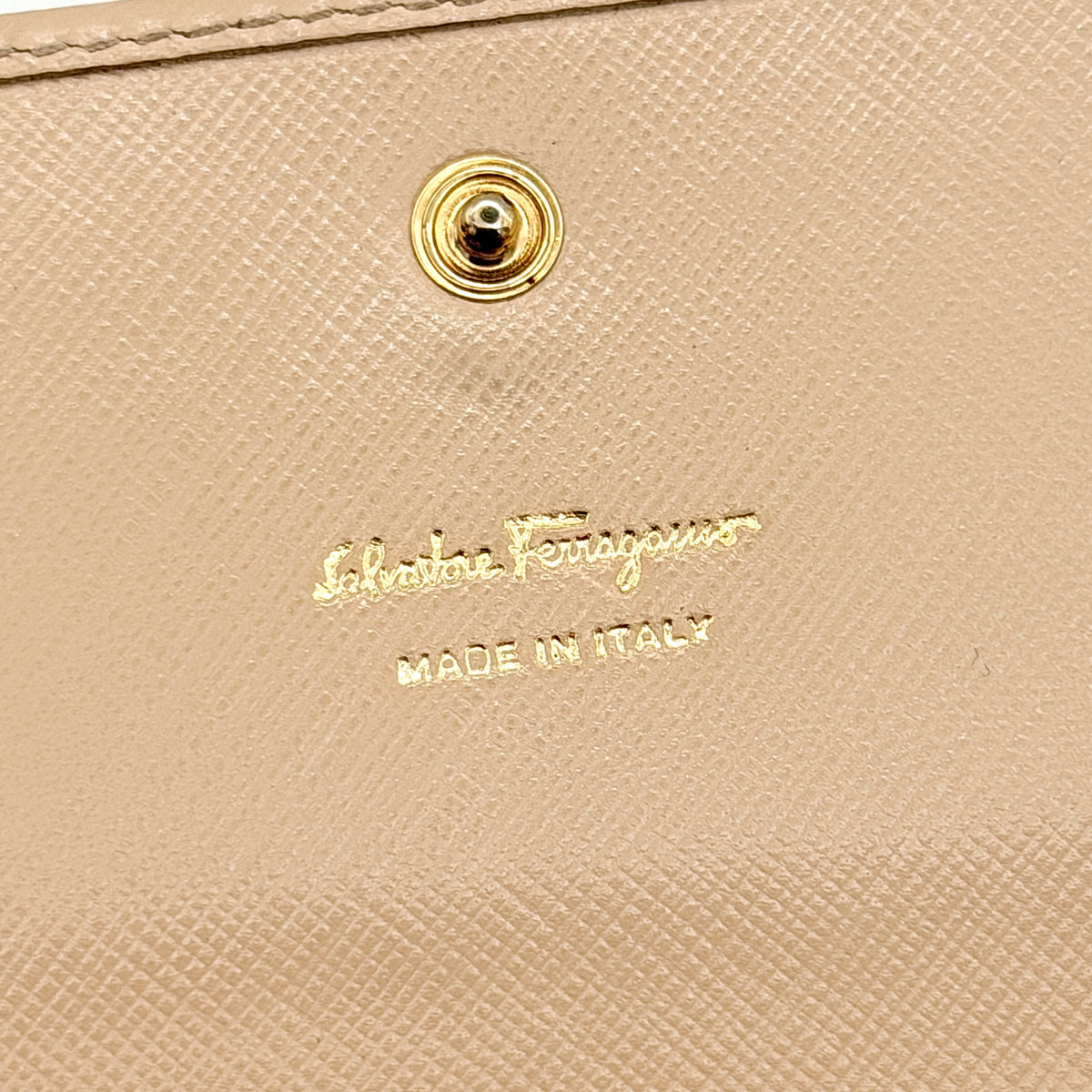 Salvatore Ferragamo light pink Saffiano wallet with gold Gancini hardware, shown on a white background.