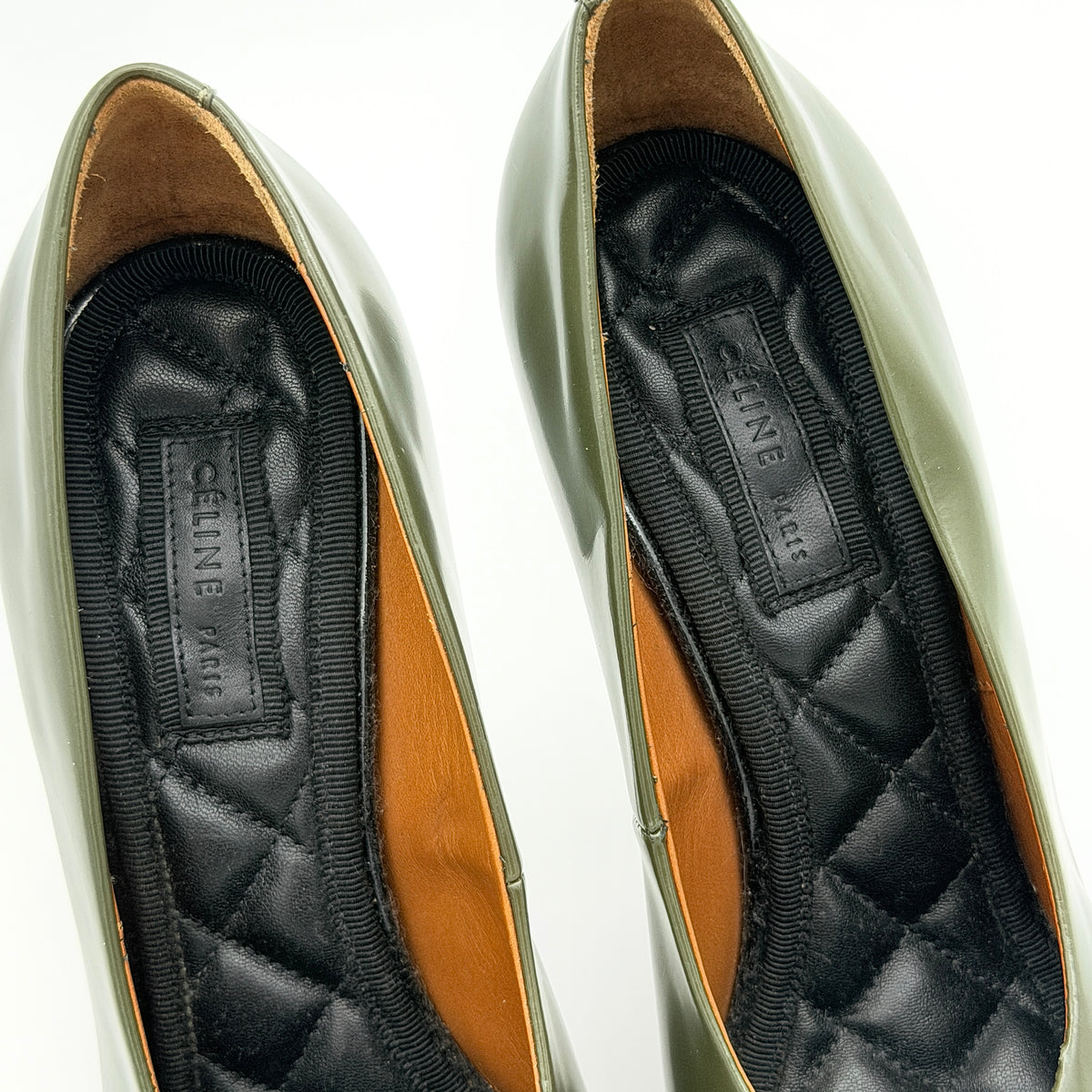 Celine olive green leather heels with pointed toe and black stiletto heel, displayed against a white background
