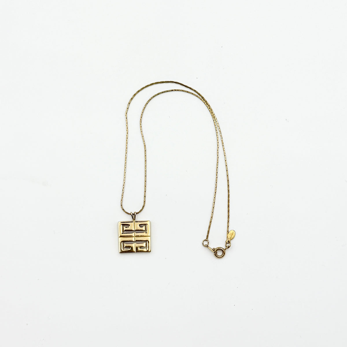 Givenchy 4G Logo Necklace in polished gold-tone metal with a geometric pendant on a fine chain.