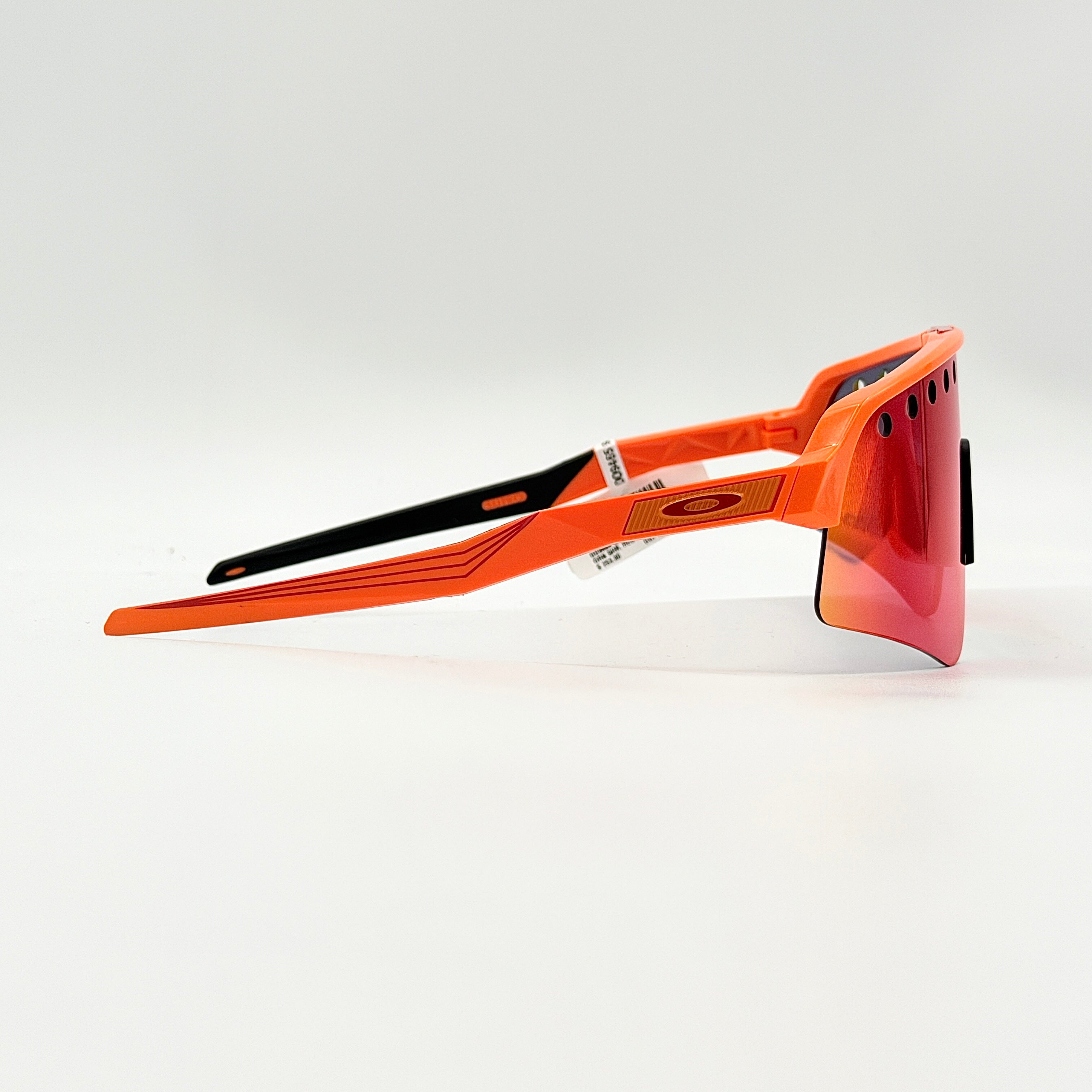 Oakley Sutro Lite Sweep MVDP Prizm Road sunglasses in orange sparkle with a shield lens and original pouch, photographed in bright studio lighting.