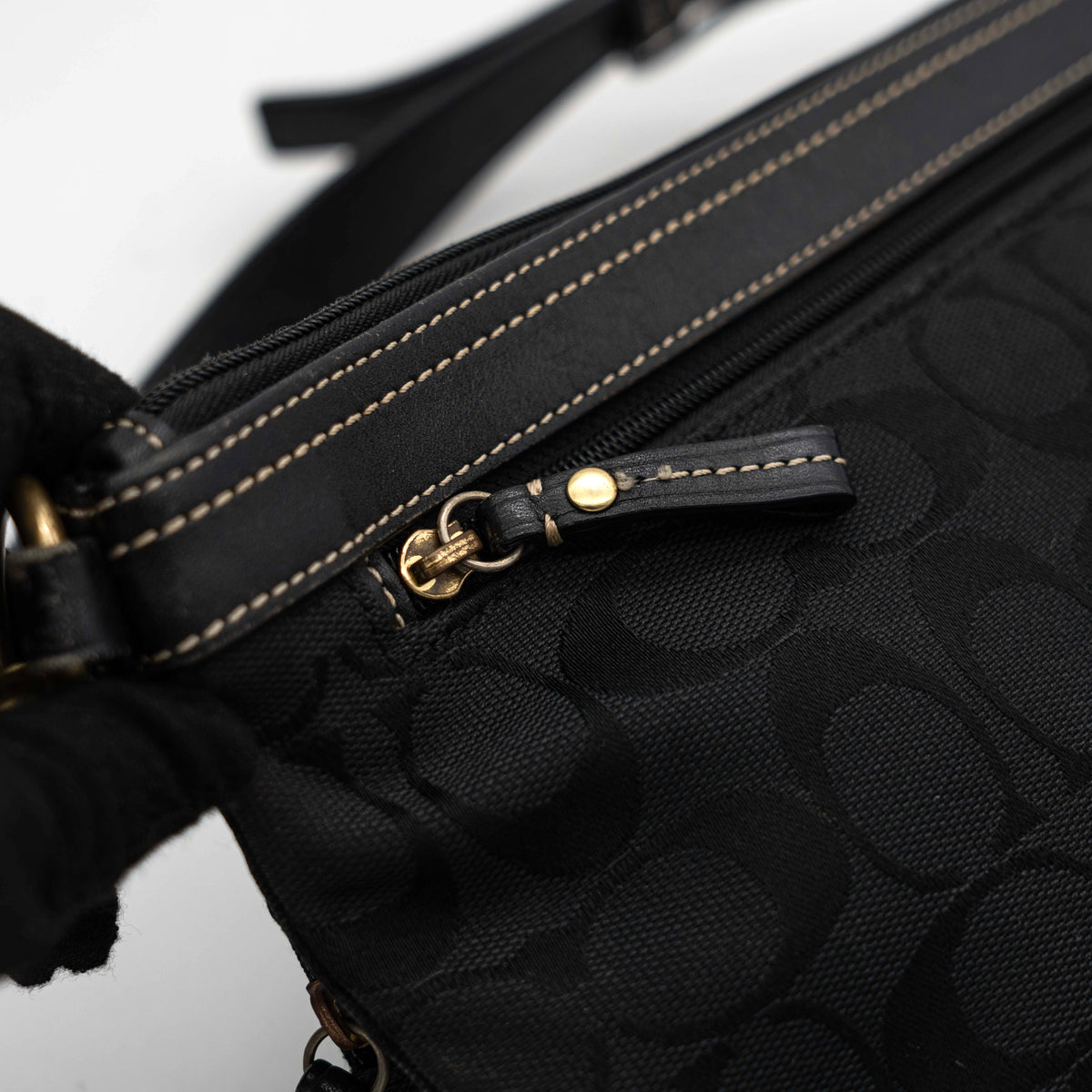 Coach Signature Double Pocket Shoulder Bag in black jacquard with dual zip pockets and an adjustable leather strap.