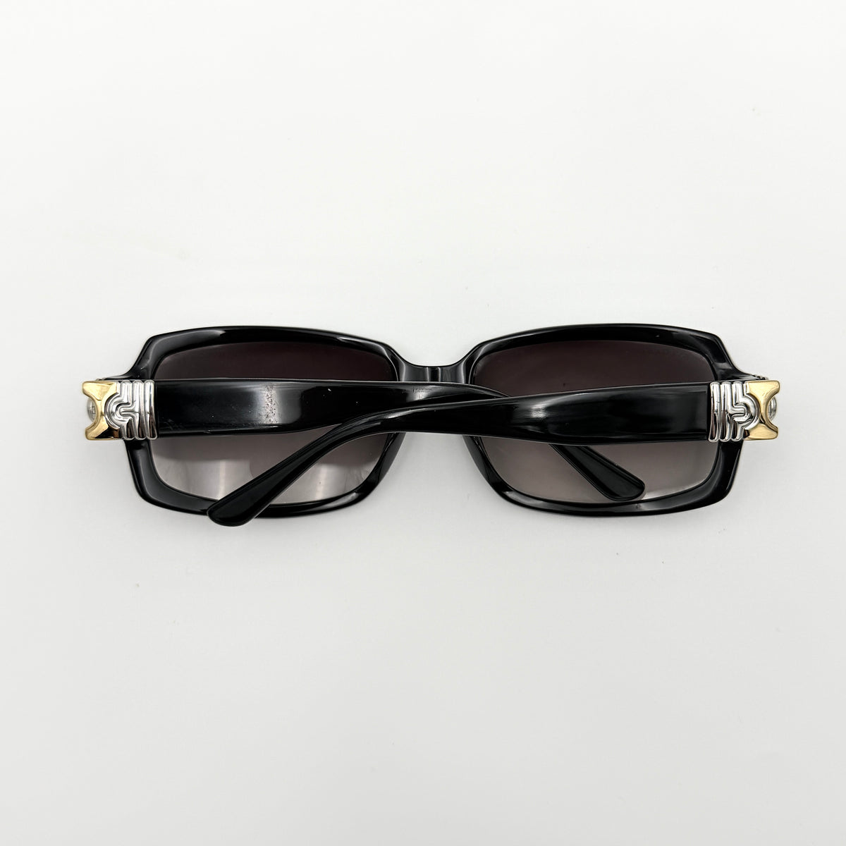 Bvlgari 829 501/11 black sunglasses with silver and gold temple hardware, displayed with case and cleaning cloth.