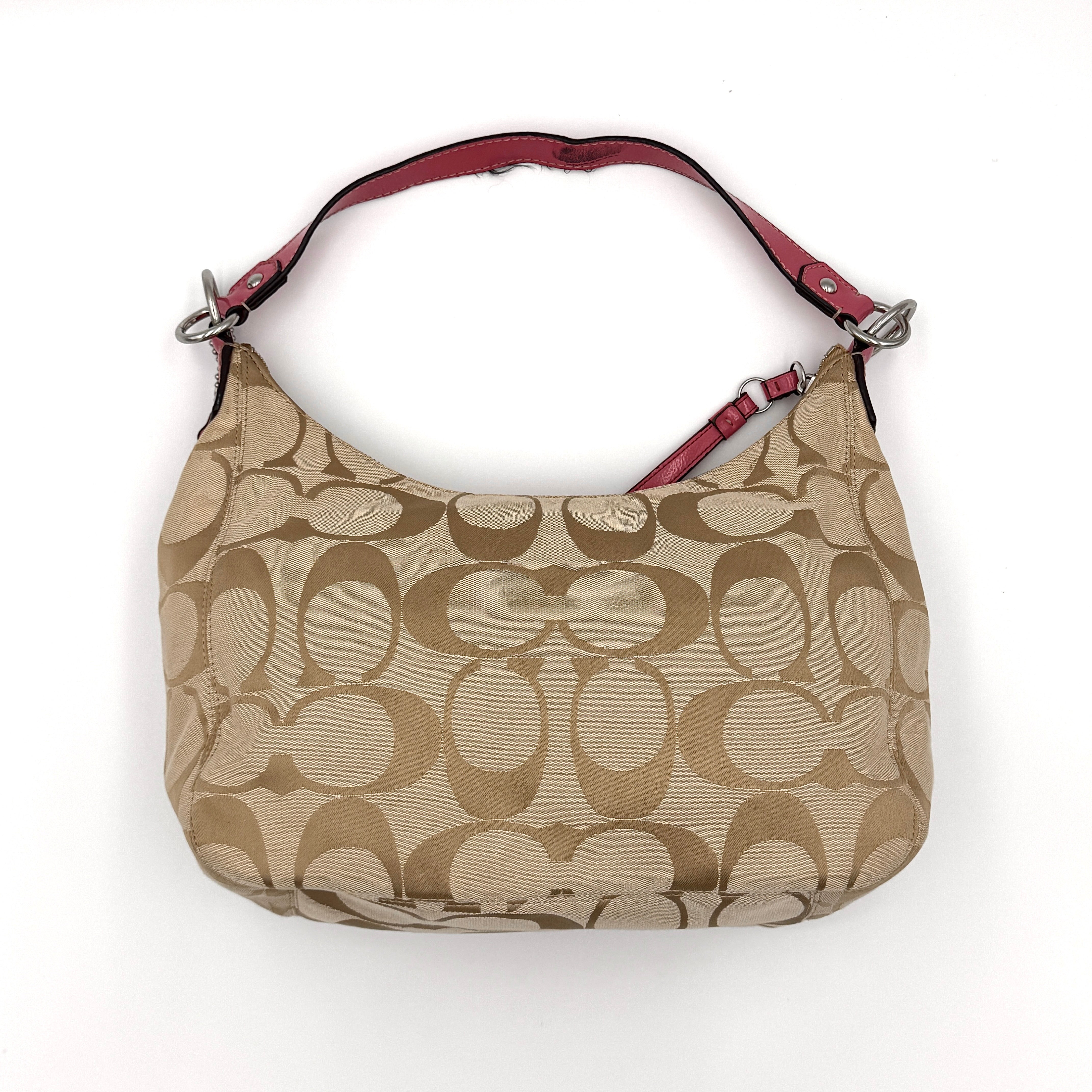 Coach Signature Stripe Hobo Shoulder Bag in beige jacquard canvas with bold pink central stripe and pink leather shoulder strap.