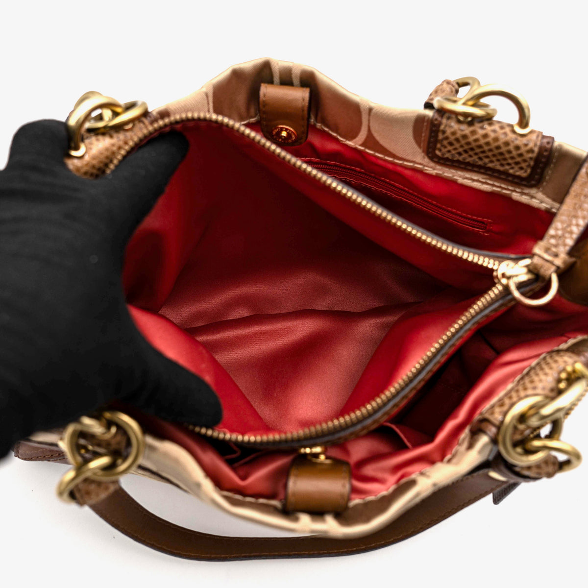 Coach Signature Peyton Shoulder Bag in brown sateen and leather with gold-tone hardware and turnlock pocket, photographed on a white background.